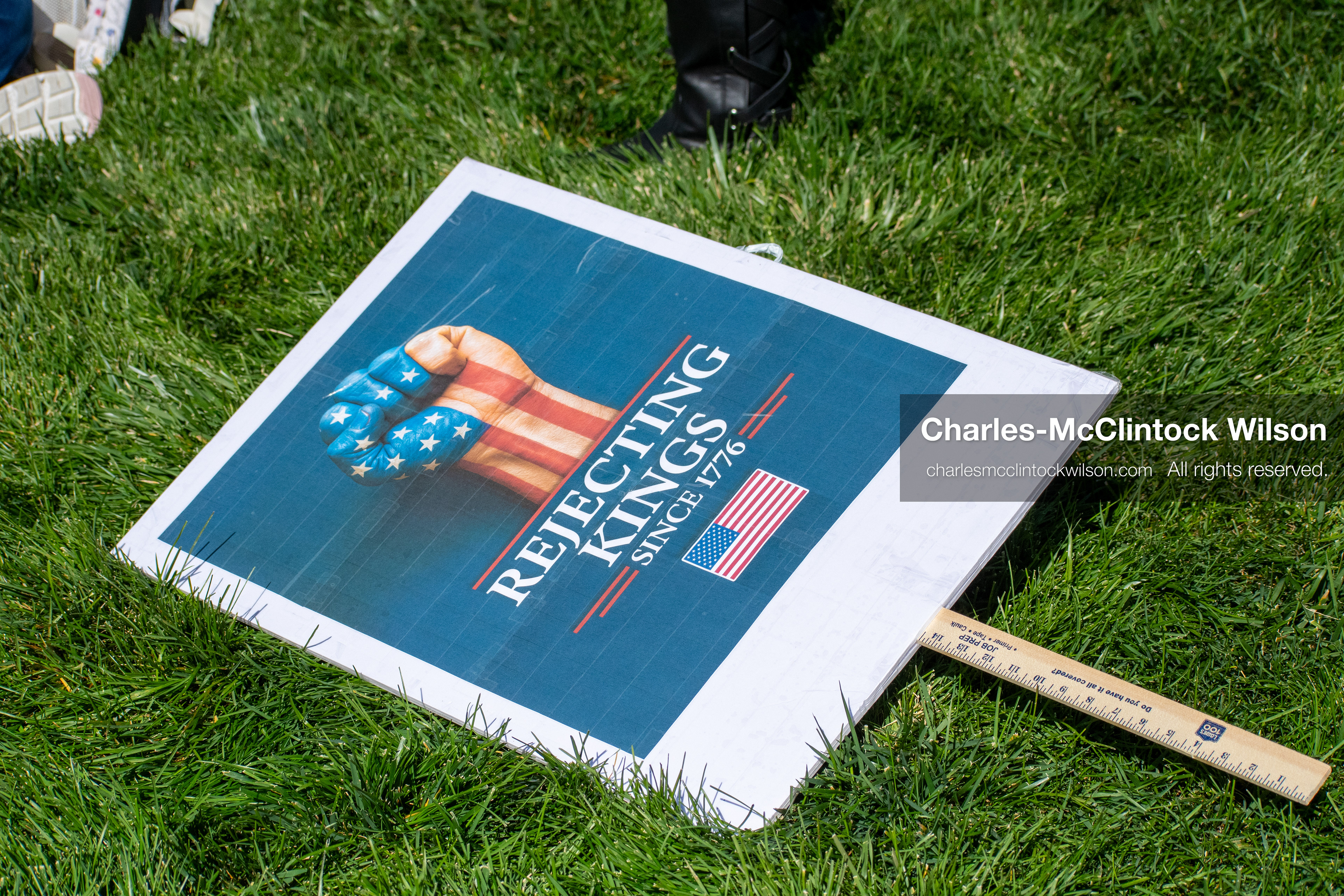 October 18, 2025, Salt Lake City, Utah, USA: A protest placard lies on the grass during a "No Kings" demonstration held at the Utah State Capitol.