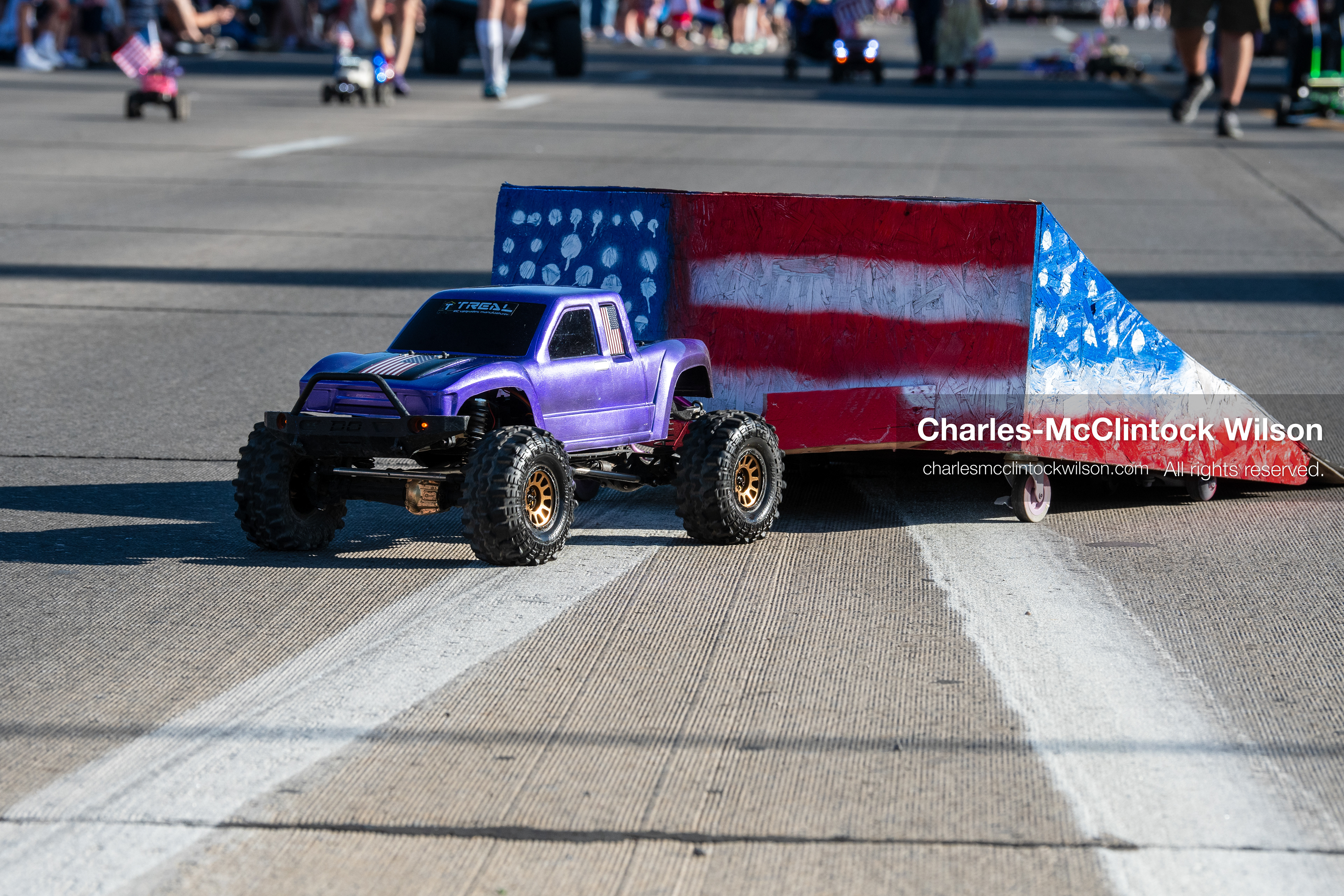 July 4, 2026, Provo, Utah, USA: A remote-controlled purple monster truck rolls down the street alongside a small, painted ramp featuring a patriotic flag pattern during America's Freedom Festival Grand Parade in Provo, Utah, Saturday, July 4, 2026. The annual Independence Day event features expanded programming to honor the 250th anniversary of United States independence. (Credit Image: © Charles-McClintock Wilson/ZUMA Press Wire)