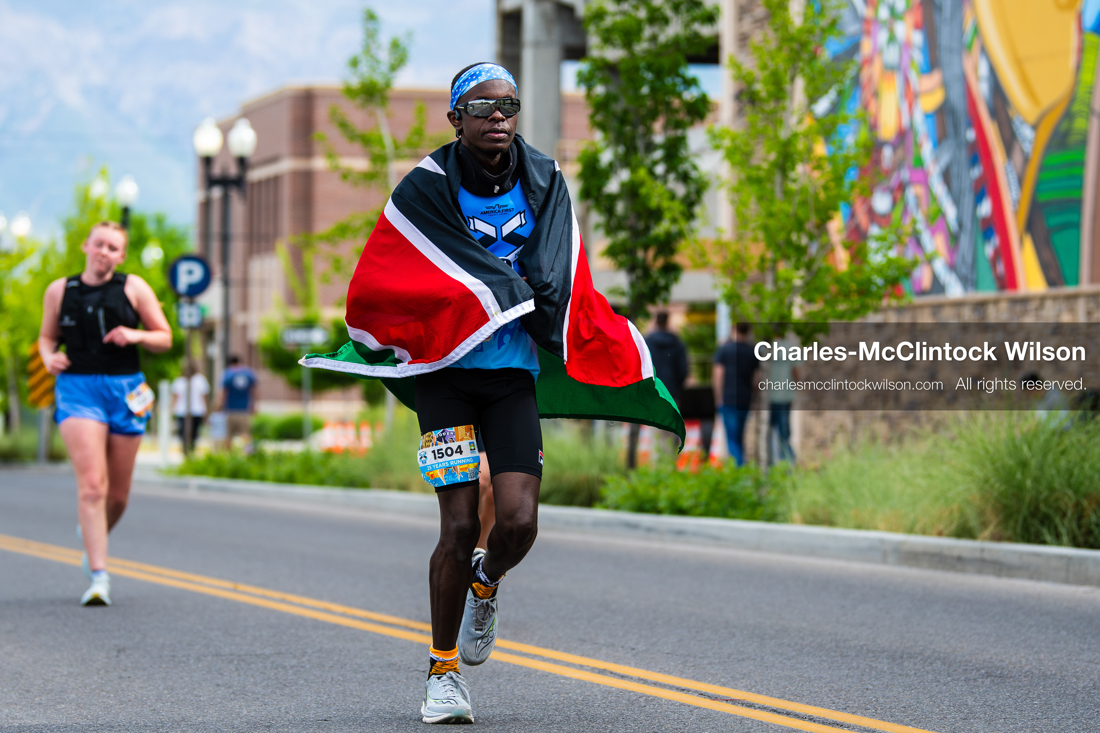May 16, 2026, Ogden, Utah, USA: A runner draped in the Kenyan flag competes in the 25th Annual America First Ogden Marathon in Ogden, Utah, on Saturday, May 16, 2026. The event drew thousands of participants and spectators for the milestone 25th running of the marathon. (Credit Image: © Charles-McClintock Wilson/ZUMA Press Wire)