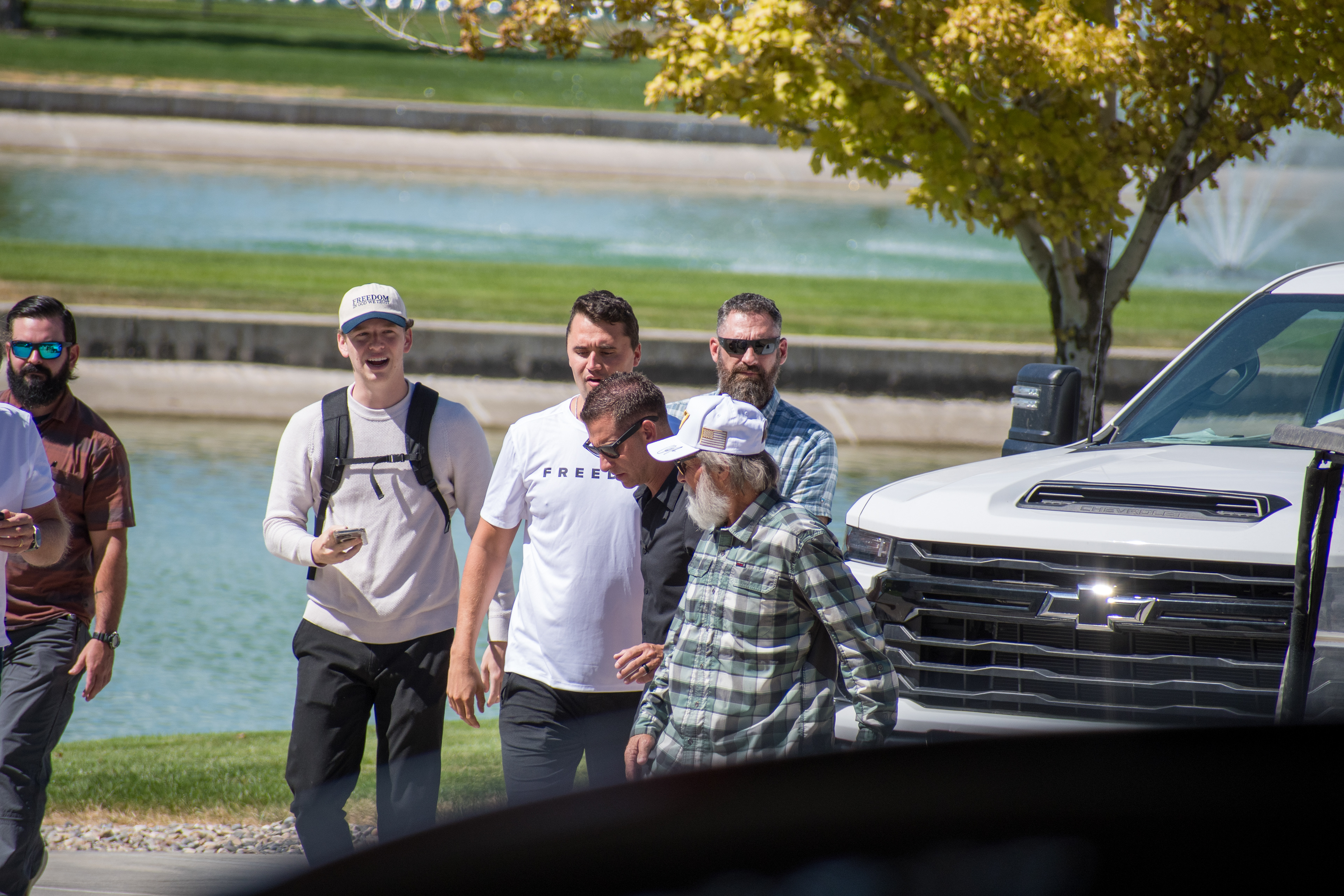 OREM, UTAH – SEPTEMBER 10, 2025: Charlie Kirk arrives at Utah Valley University for a scheduled public event. Walking near a water feature and surrounded by staff and supporters, Kirk enters the venue in a moment of calm anticipation. The image marks the beginning of his final public appearance, reflecting the quiet buildup before the crowd engagement that followed. © Charles-McClintock Wilson / ZUMA Press