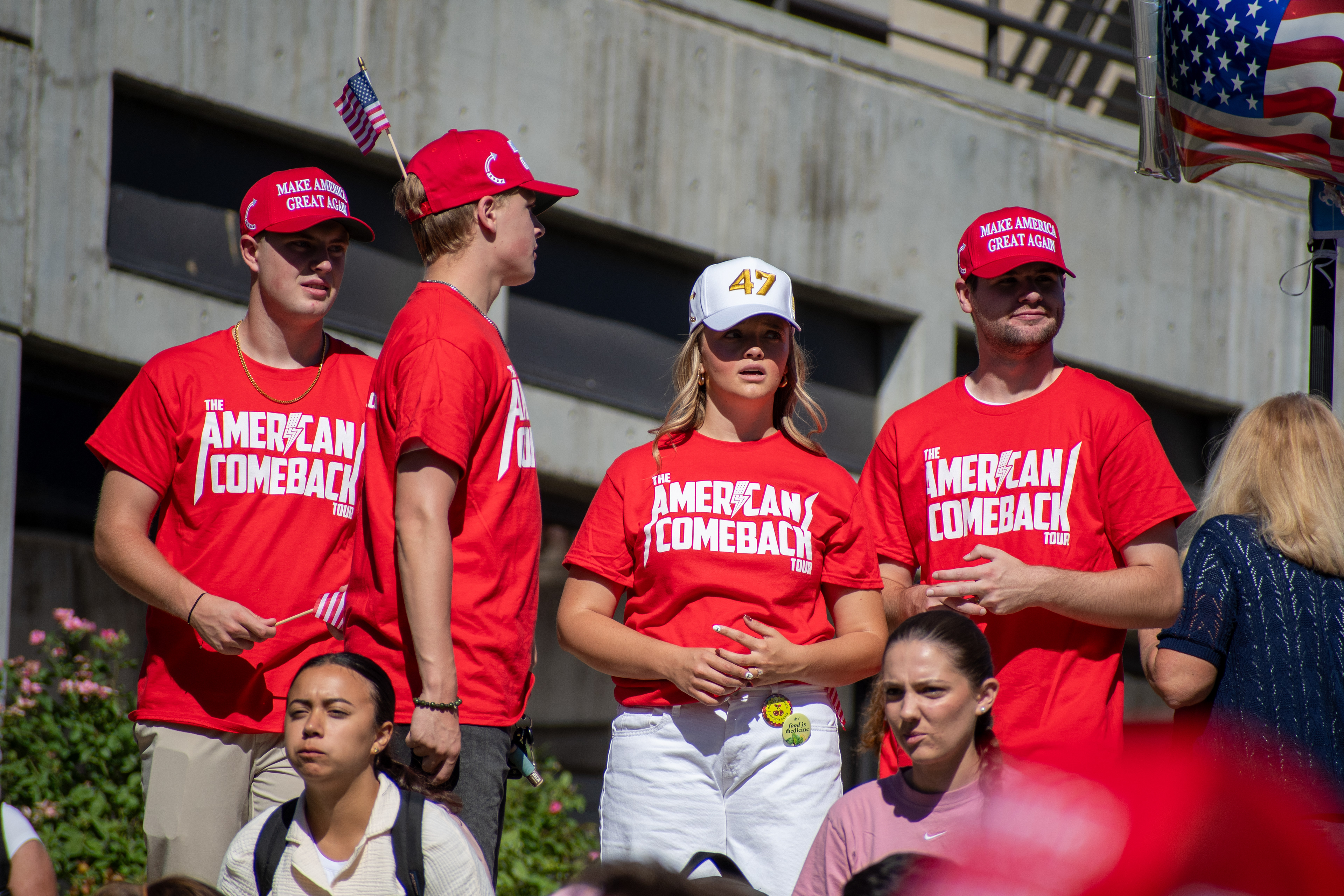 OREM, UTAH – SEPTEMBER 10, 2025: A group of attendees stands together at Utah Valley University during the opening stop of the American Comeback Tour. Wearing matching red shirts that read “The American Comeback,” the individuals reflect a moment of shared purpose, visual unity, and civic engagement. The image captures the emotional texture and communal presence that shaped the event’s intended spirit. © Charles-McClintock Wilson / ZUMA Press