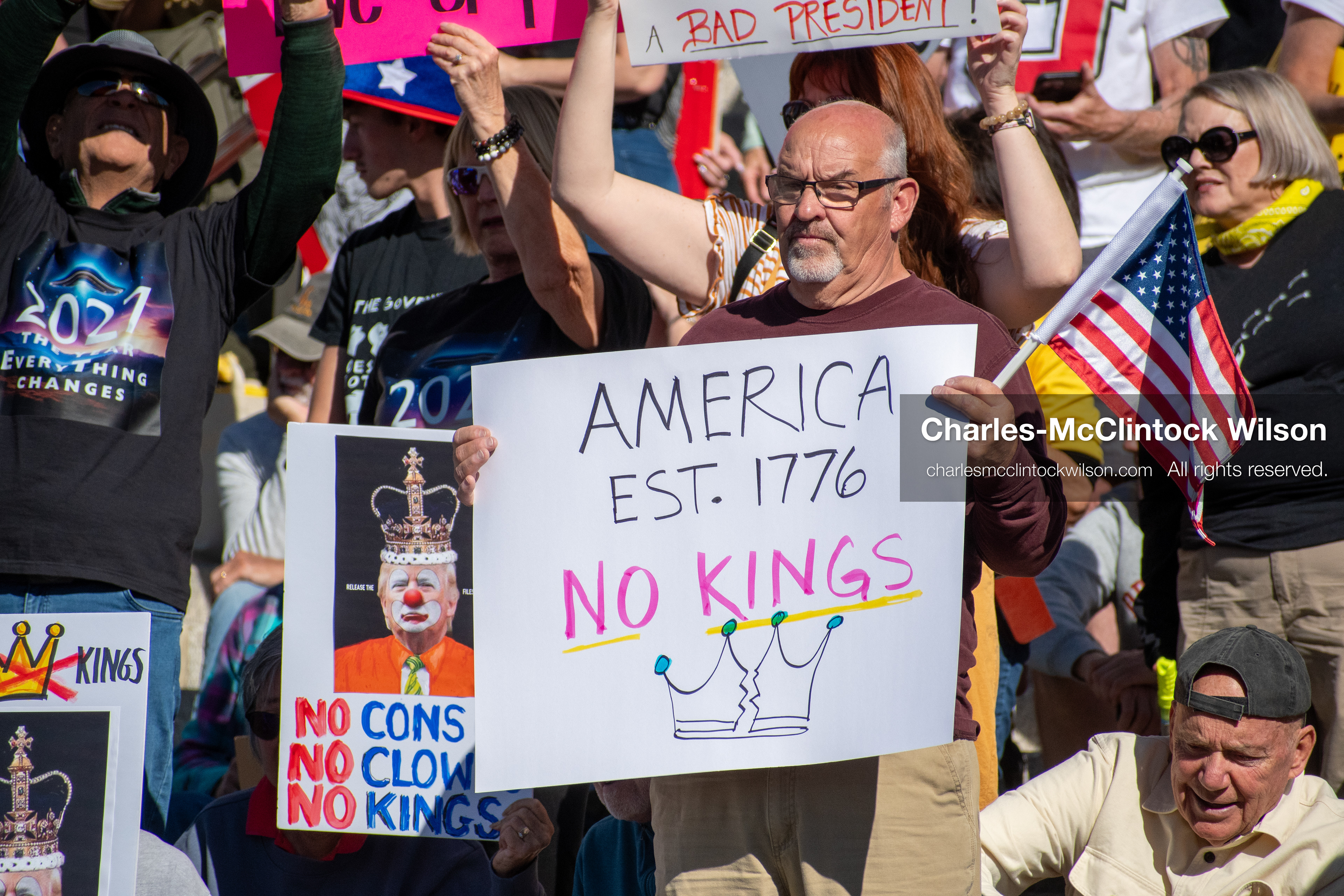 October 18, 2025, Salt Lake City, Utah, USA: Demonstrators gather on the steps of the Utah State Capitol during a "No Kings" protest held as part of a nationwide mobilization. Participants hold signs and flags while documenting the event. The protest was one of several organized across the United States.