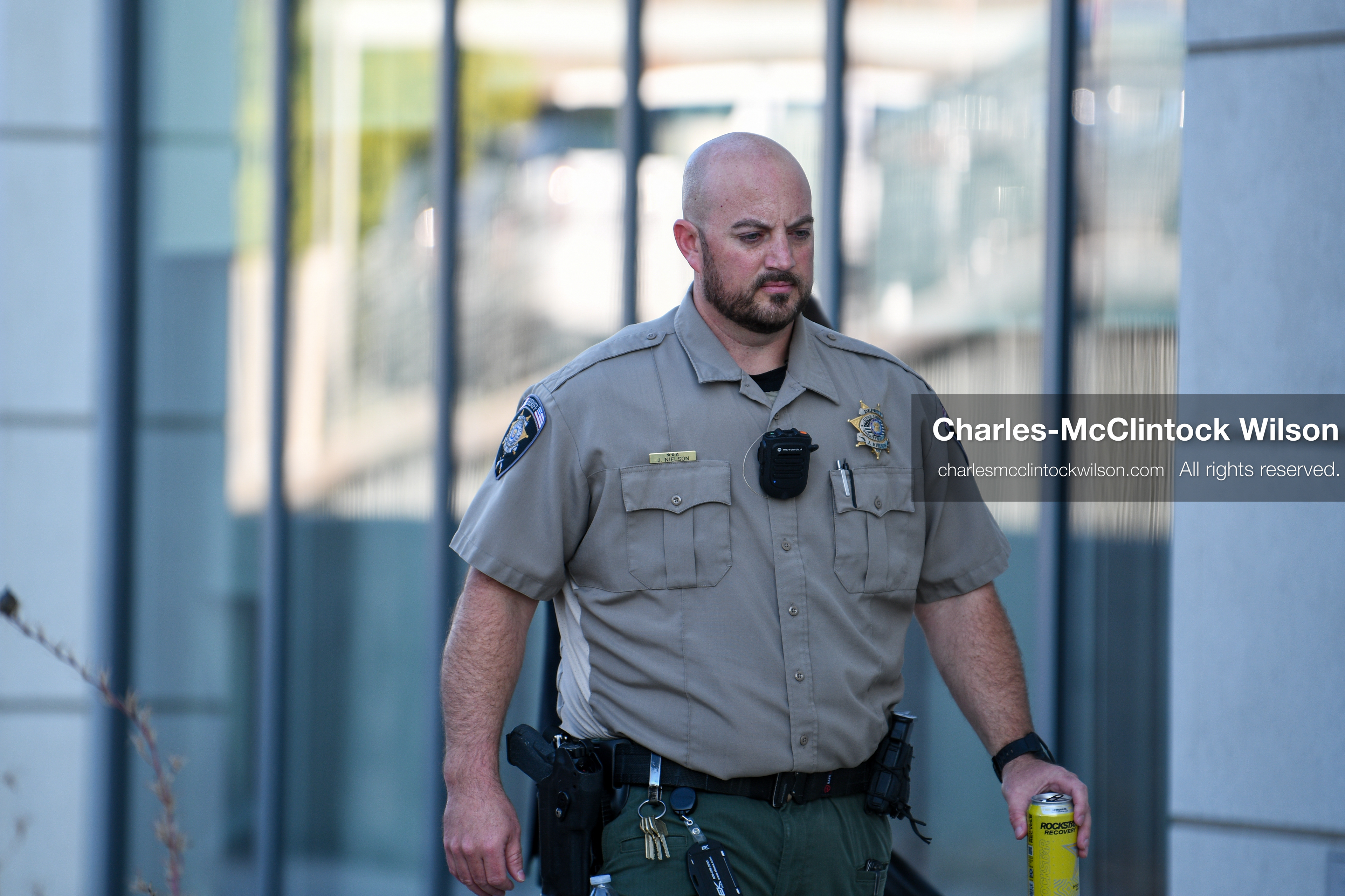 PROVO, UTAH, USA – DECEMBER 11, 2025: A Utah County Sheriff’s Office officer patrols the parking lot of the Fourth District Court in Provo during the first in‑person court appearance of Tyler Robinson in the Charlie Kirk murder case. (Credit Image: © Charles‑McClintock Wilson/ZUMA Press Wire)