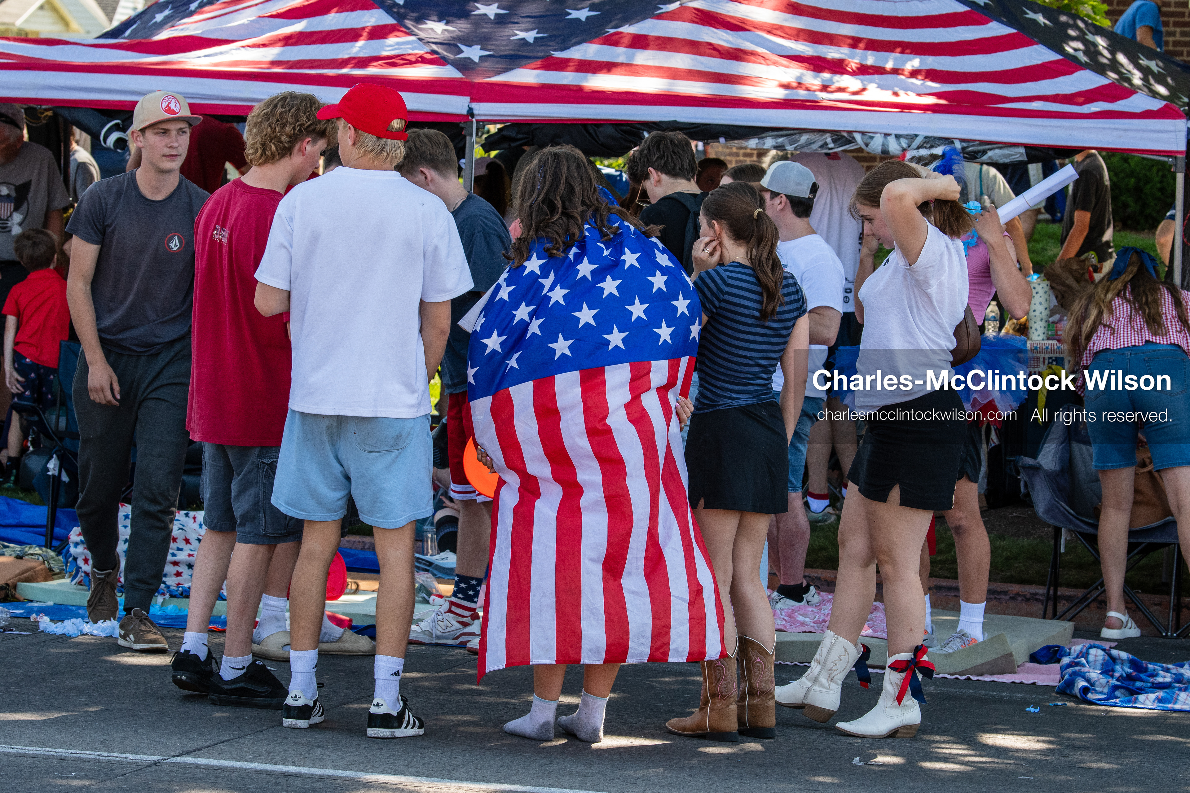 July 4, 2026, Provo, Utah, USA: Spectators, including a person draped in an American flag, gather along the sidewalk to watch America's Freedom Festival Grand Parade in Provo, Utah, Saturday, July 4, 2026. The annual event drew thousands of spectators to the downtown corridor. (Credit Image: © Charles-McClintock Wilson/ZUMA Press Wire)