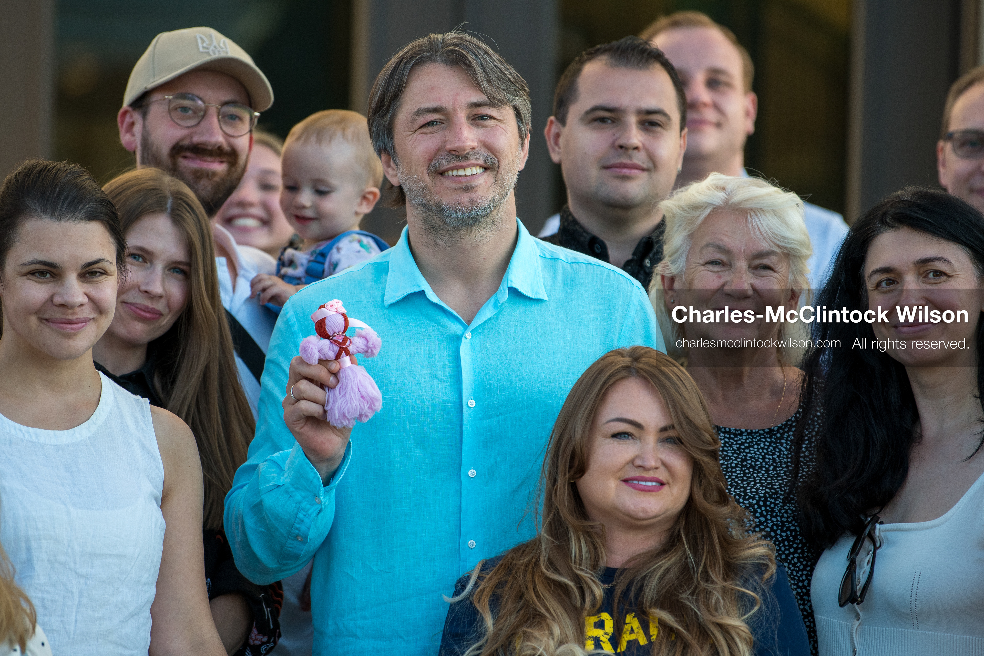 July 23, 2026, Salt Lake City, Utah, USA: Ukrainian activist SERHIY PRYTULA holds a small doll while posing for a group photograph with supporters during a community meeting at the Utah State Capitol building in Salt Lake City, Utah, on Thursday, July 23, 2026. The event, titled ''Ukraine in the Fifth Year of the Full-Scale War: An Honest Conversation,'' was hosted by the Prytula Foundation USA to discuss civil defense and ongoing humanitarian aid initiatives. (Credit Image: © Charles-McClintock Wilson/ZUMA Press Wire)
