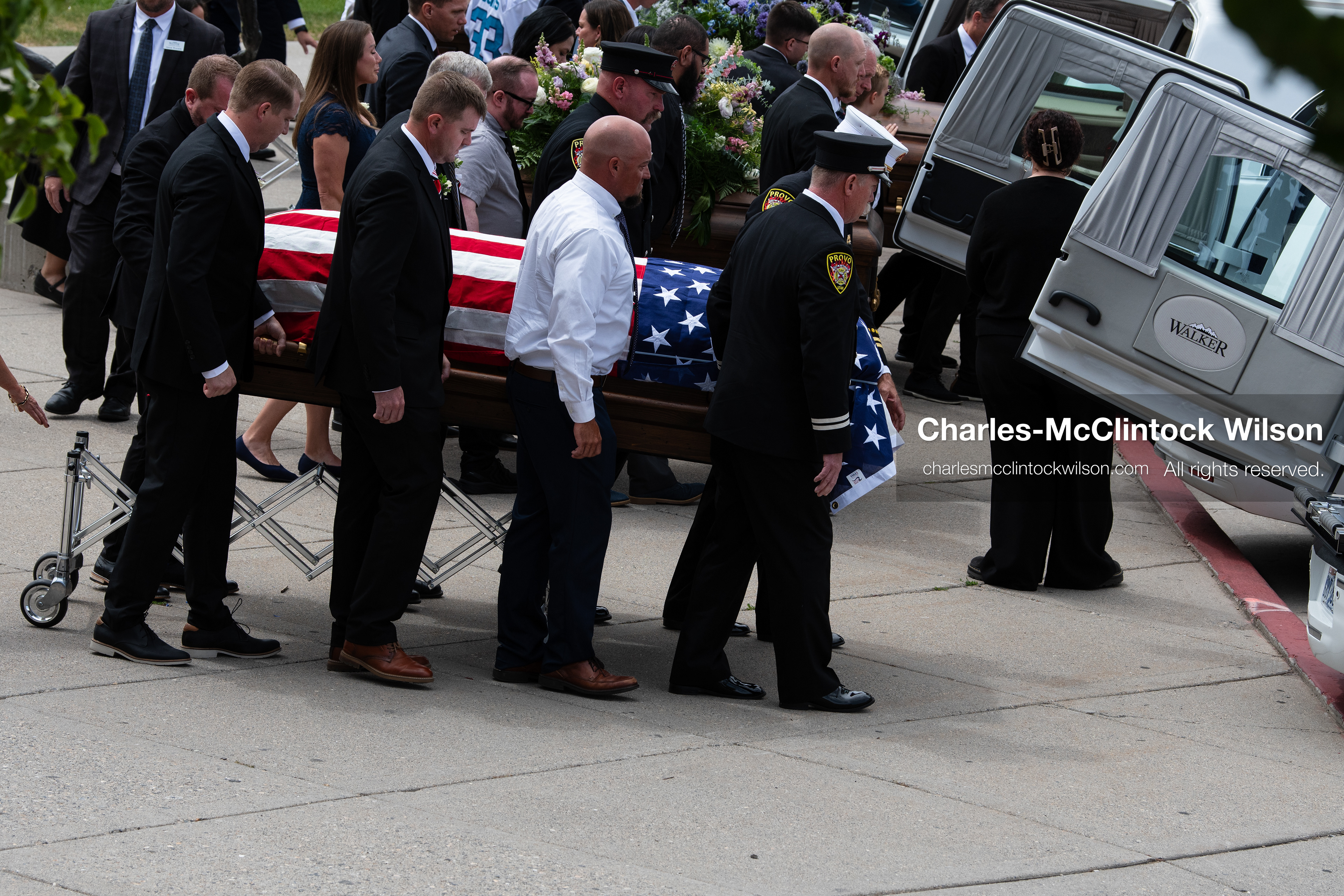 Firefighters and pallbearers load the flag-draped casket of Provo Fire Captain Spencer Long into a white hearse outside the UCCU Center at Utah Valley University in Orem, Utah, on Wednesday, July 29, 2026. More than 300 people came to the public memorial ceremony to honor Captain Long, his wife Katrina, and three of their sons, who died after a flash flood hit their campsite near the Sunglow Campground in Wayne County. (Photo by Charles-McClintock Wilson/Sipa USA)