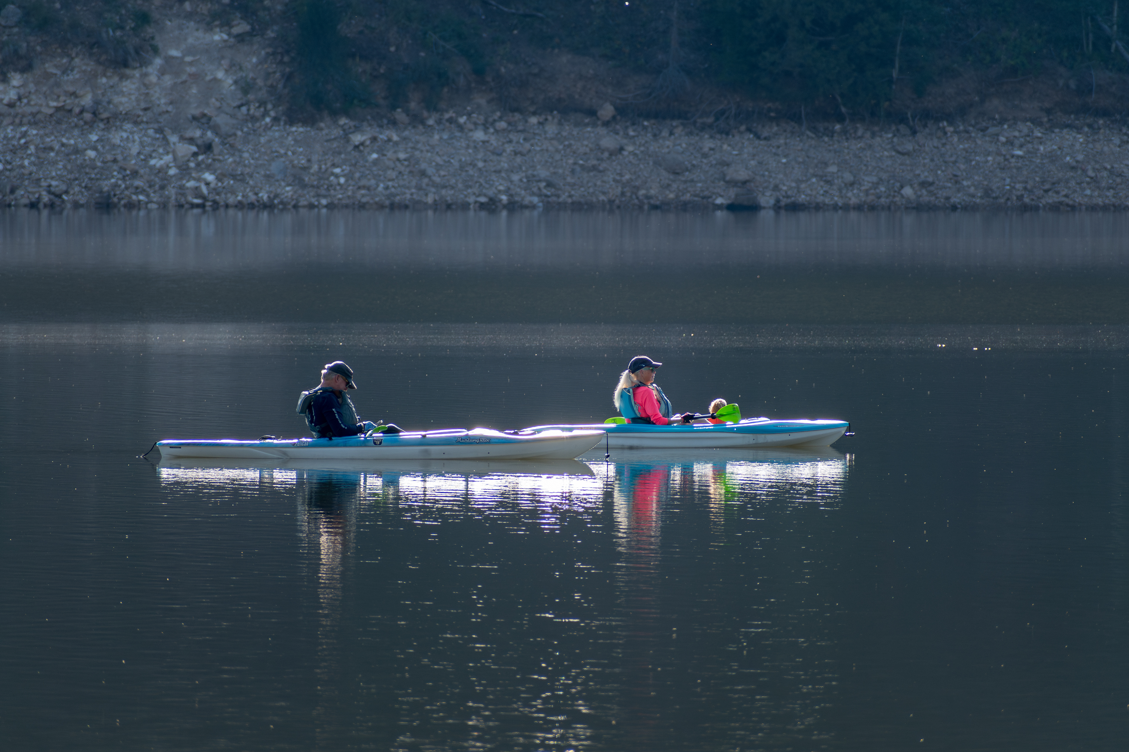 Summit County, Utah – July 20, 2025: People paddle kayaks across the calm waters of Smith and Morehouse Reservoir during a summer outing.