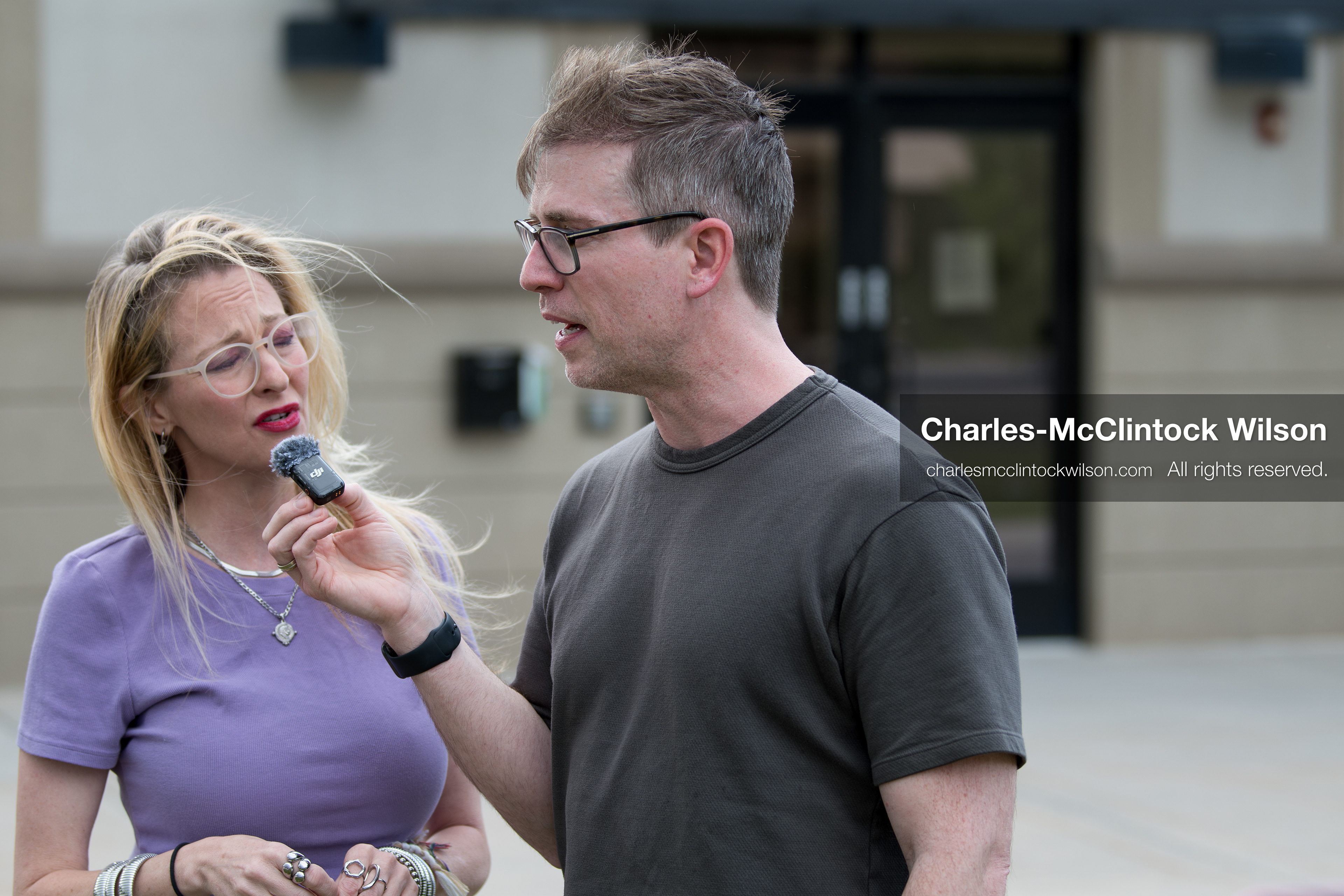 May 13, 2026, Brigham City, Utah, USA: US political satirist and digital creator WALTER MASTERSON interviews a woman outside the Box Elder County Justice Courthouse in Brigham City, Utah, during a gathering over the proposed data‑center project backed by businessman Kevin O’Leary, which has drawn public concern over water use, power demand, and transparency. (Credit Image: © Charles‑McClintock Wilson/ZUMA Press Wire)