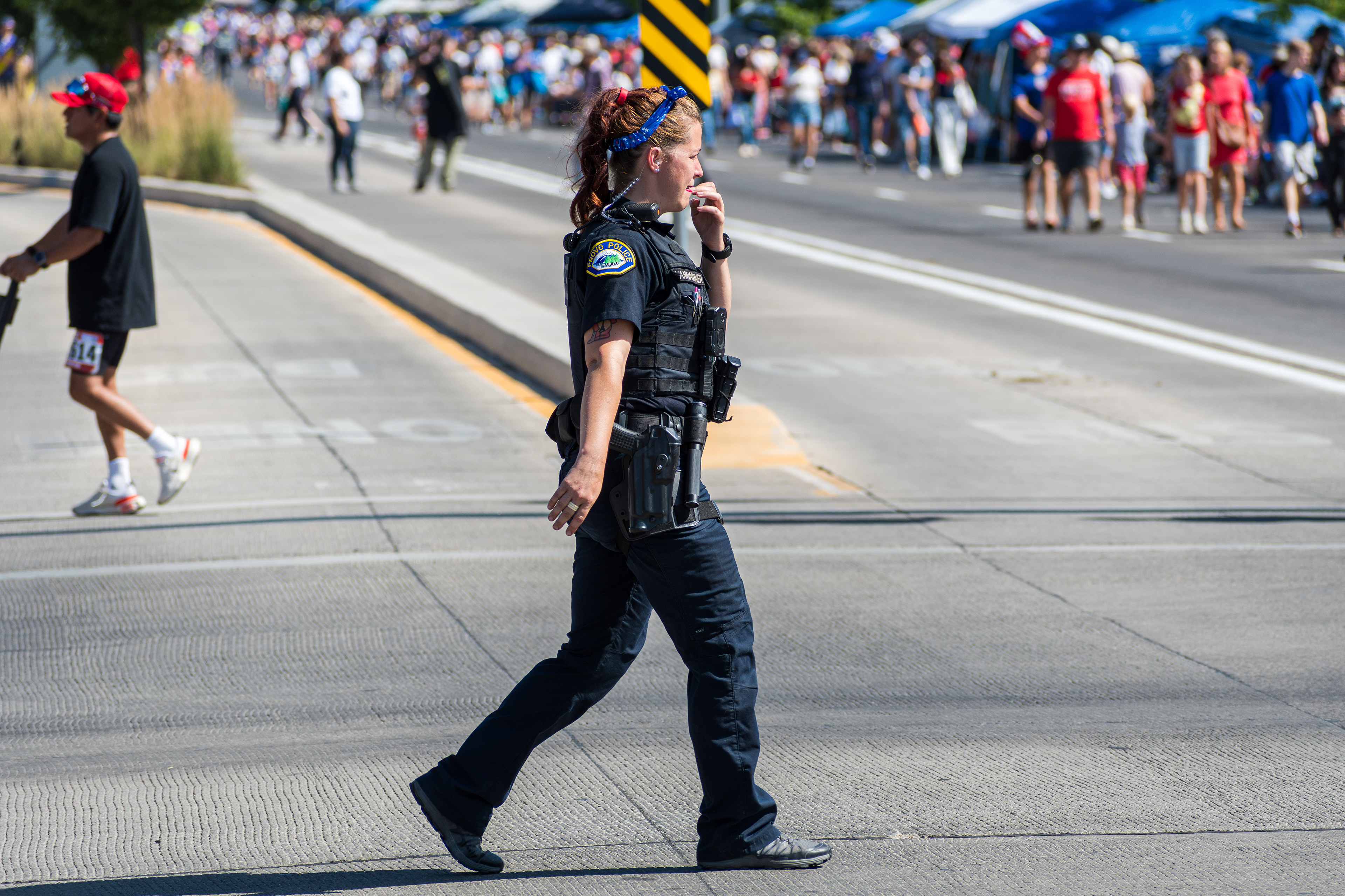 Provo, Utah – July 4, 2025: A female law enforcement officer walks along the parade route during the Freedom Festival Grand Parade in downtown Provo.