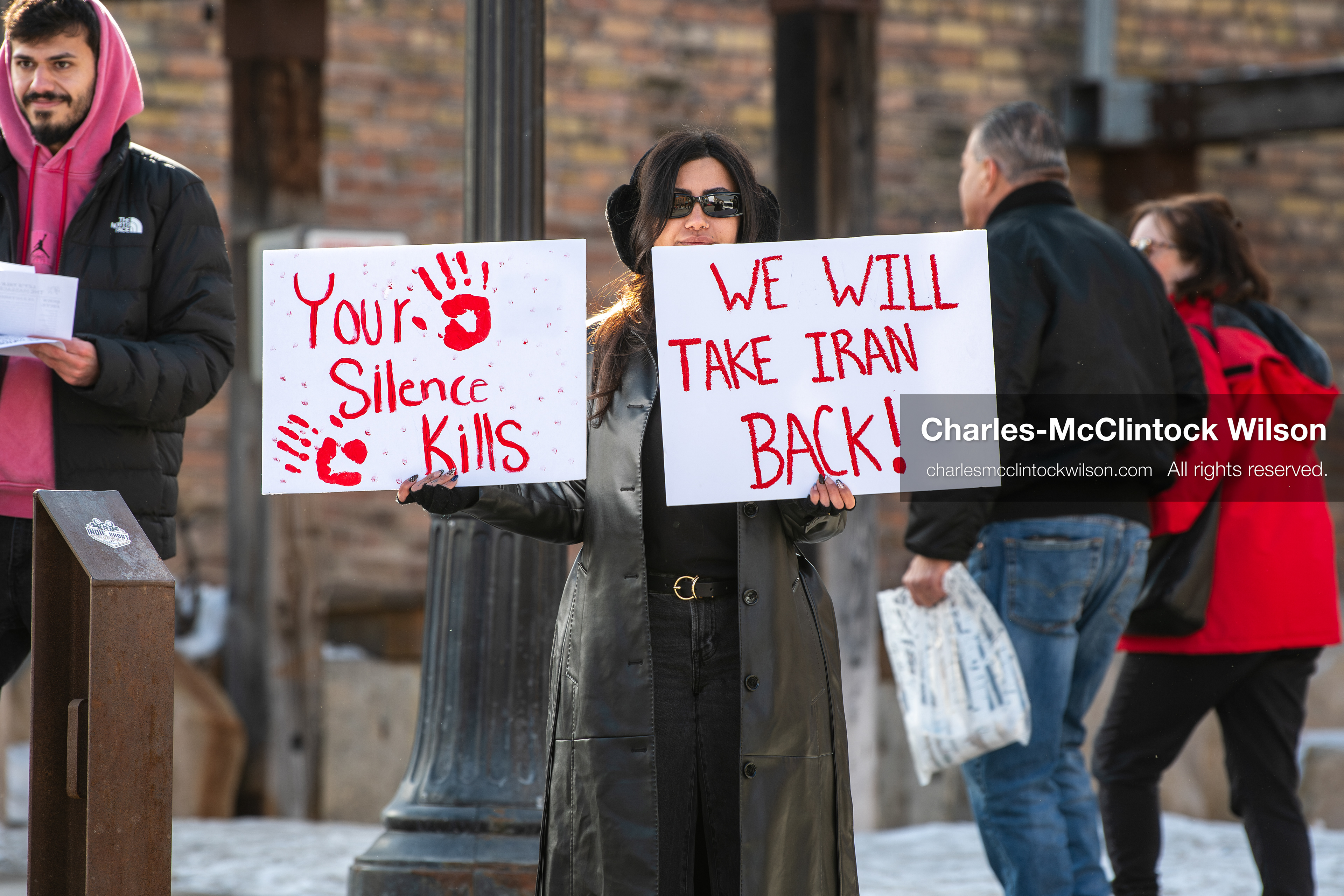 January 30, 2026, Park City, Utah, USA: A demonstrator holds signs during a small protest against the Iranian government on Main Street in Park City, Utah. (Credit Image: © Charles McClintock Wilson/ZUMA Press Wire)