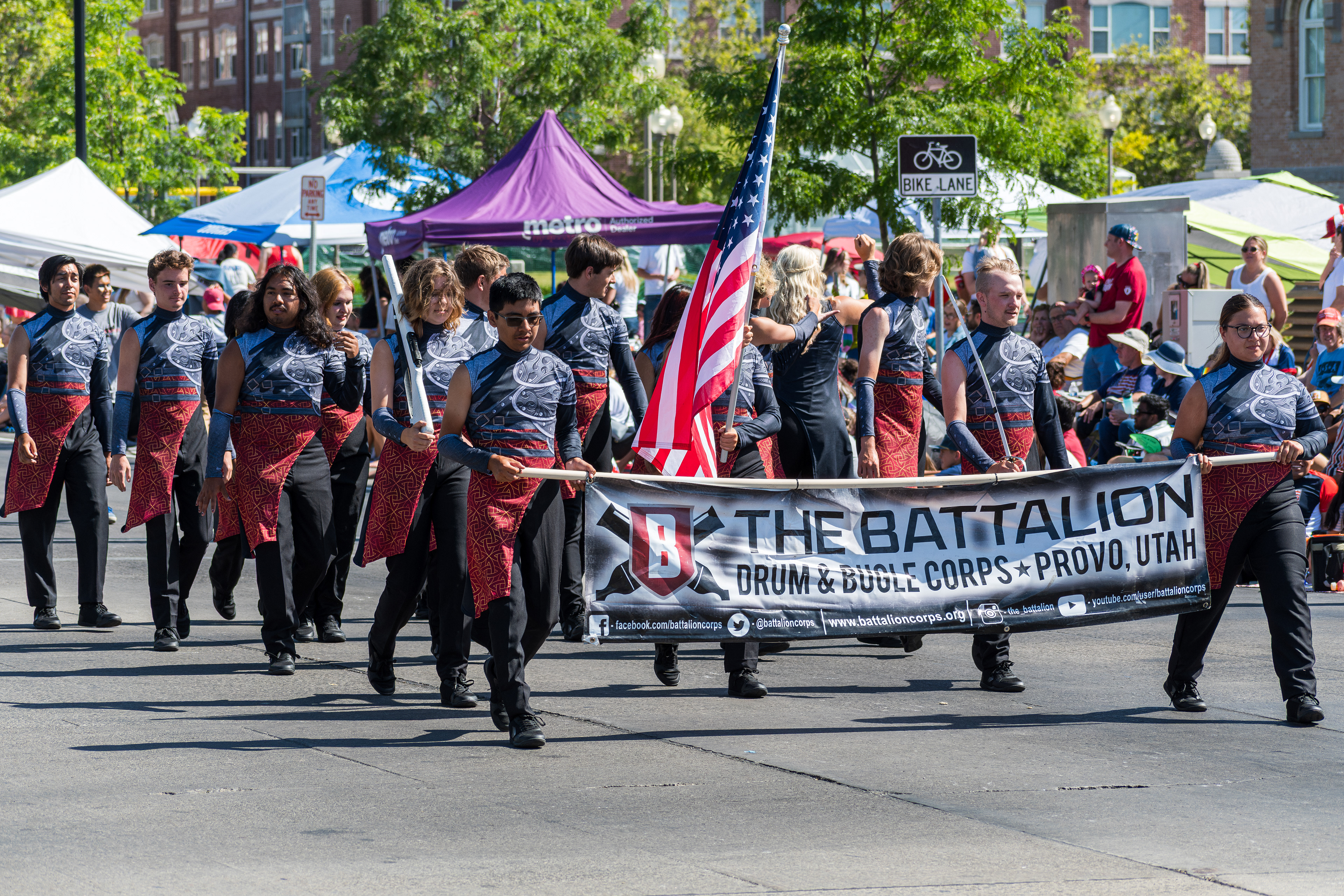 Provo, Utah – July 4, 2025: Young performers walk down Center Street holding flags during the Freedom Festival Grand Parade, joining the procession as part of the Independence Day celebration.