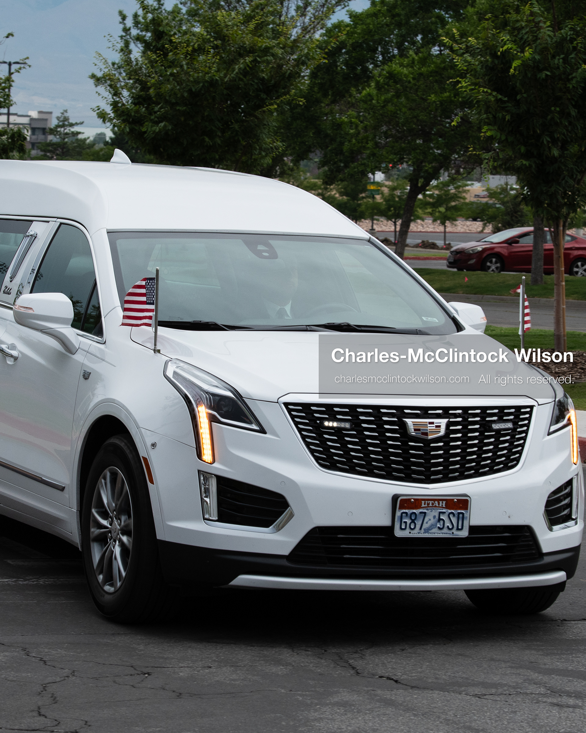 A white Cadillac hearse carrying the remains of Provo Fire Captain Spencer Long arrives at the UCCU Center at Utah Valley University in Orem, Utah, on Wednesday, July 29, 2026. The 17-year veteran of the fire department, along with his wife and three sons, lost their lives after flash floods struck their campsite in Wayne County.(Photo by Charles-McClintock Wilson/Sipa USA)
