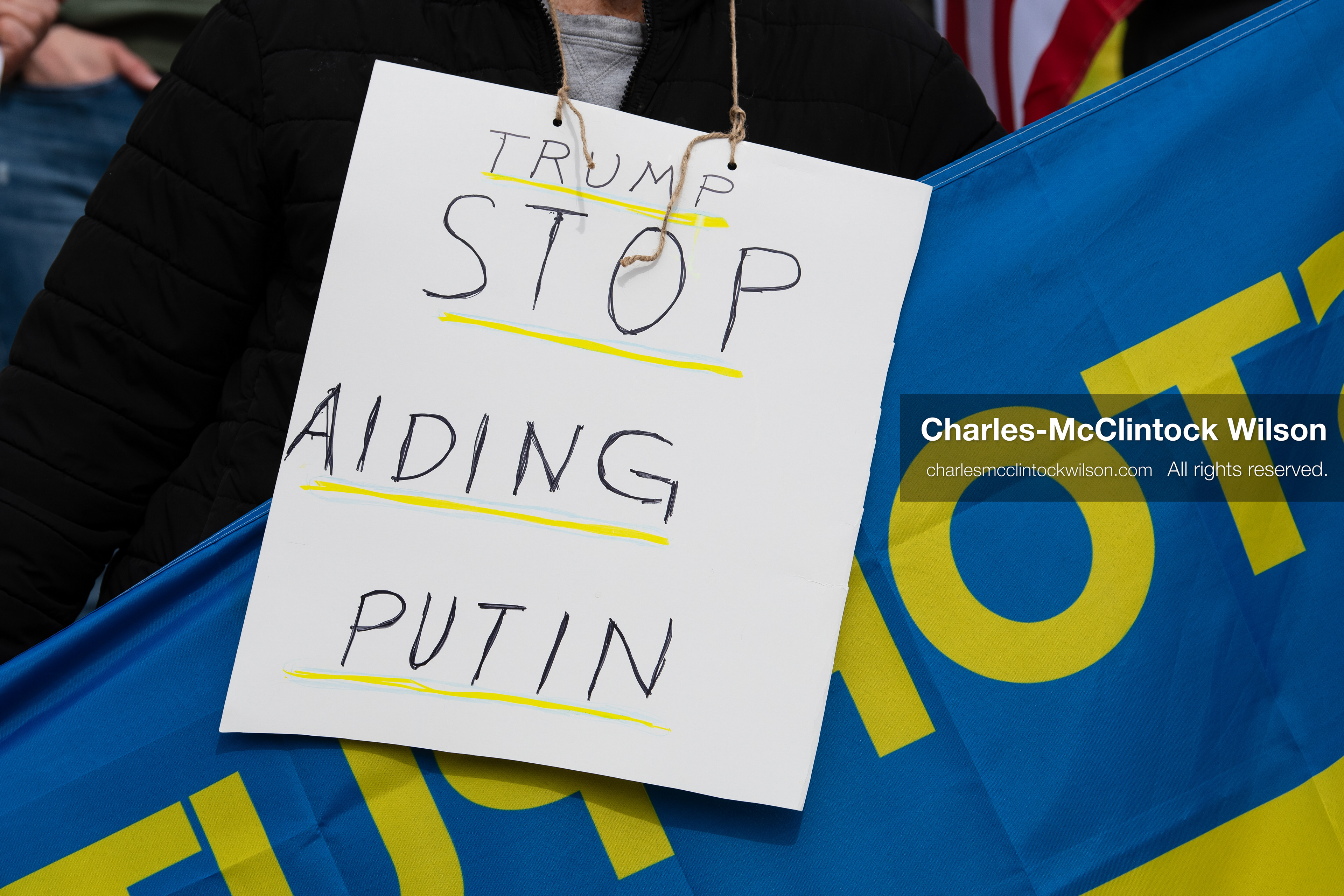 February 28, 2026, Salt Lake City, Utah, USA: A demonstrator wears a sign reading Trump Stop Aiding Putin during the Stand With Ukraine rally at the Utah State Capitol. The gathering marked the four year anniversary of the full scale Russian invasion of Ukraine and brought community members together in support of Ukrainians and local humanitarian efforts. (Credit Image: © Charles McClintock Wilson/ZUMA Press Wire)