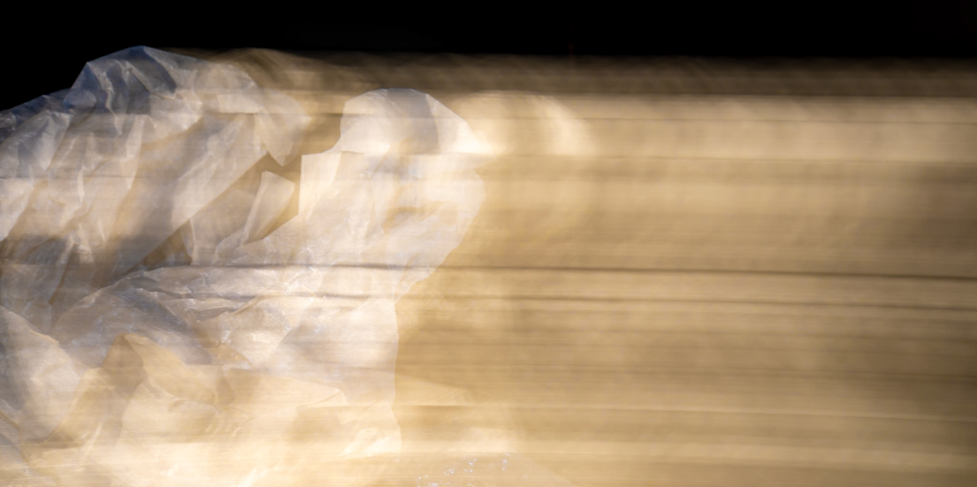 Using long shutter speeds to create movement with light highlighting the lines of the material.