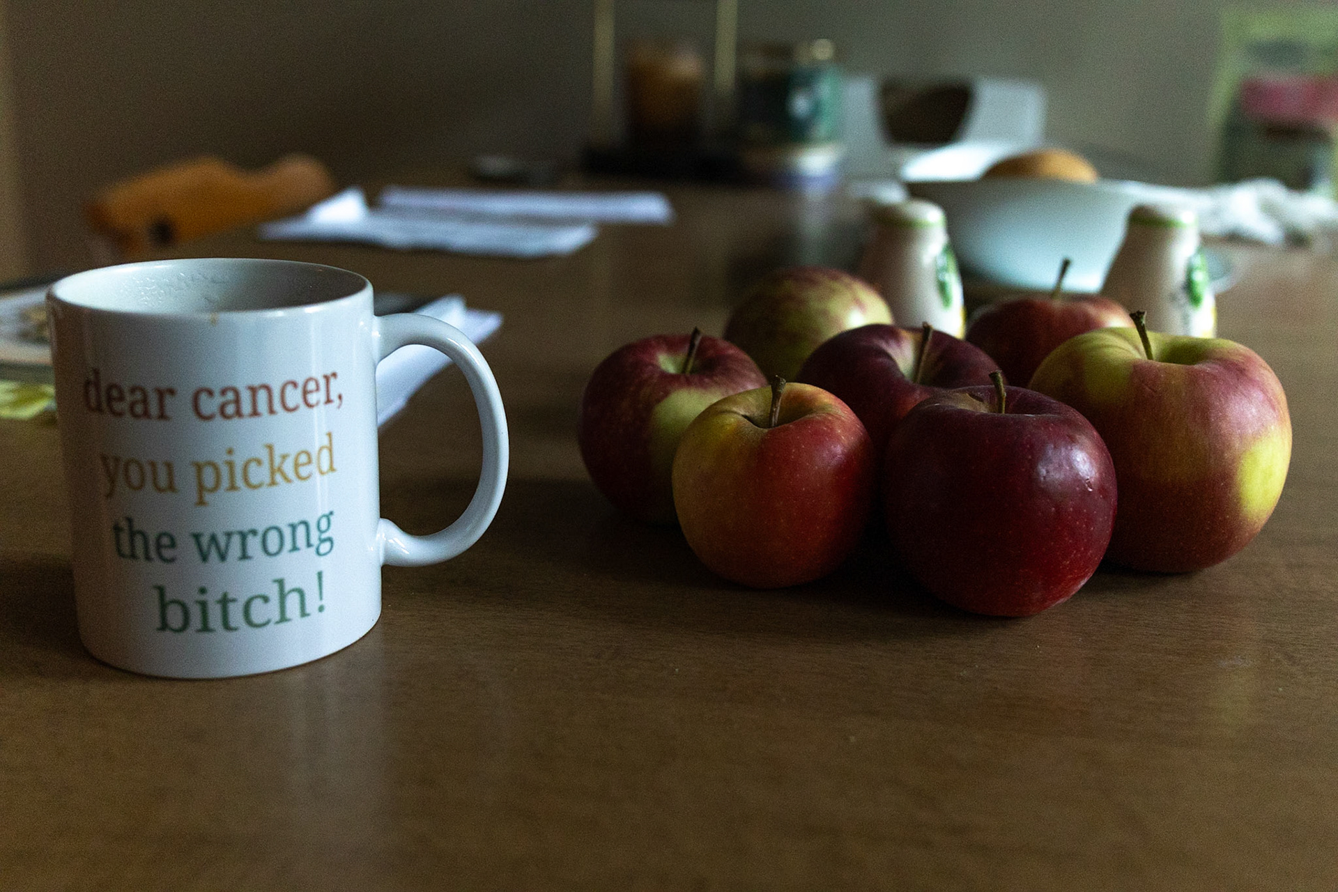 Virginia Combs has a coffee mug quoting how cancer sucks on her dining room table in Rochester, NY, on October 4, 2025. In her house, she displays or has quotes on cups or posters referencing cancer, which she is going through at this time.