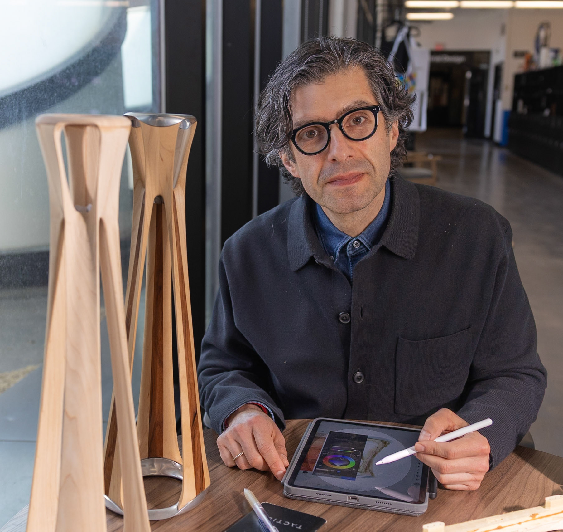 Alex Lobos, Professor and Director of the School of Design at Rochester Institute of Technology, stands among his industrial design products on March 27, 2025.