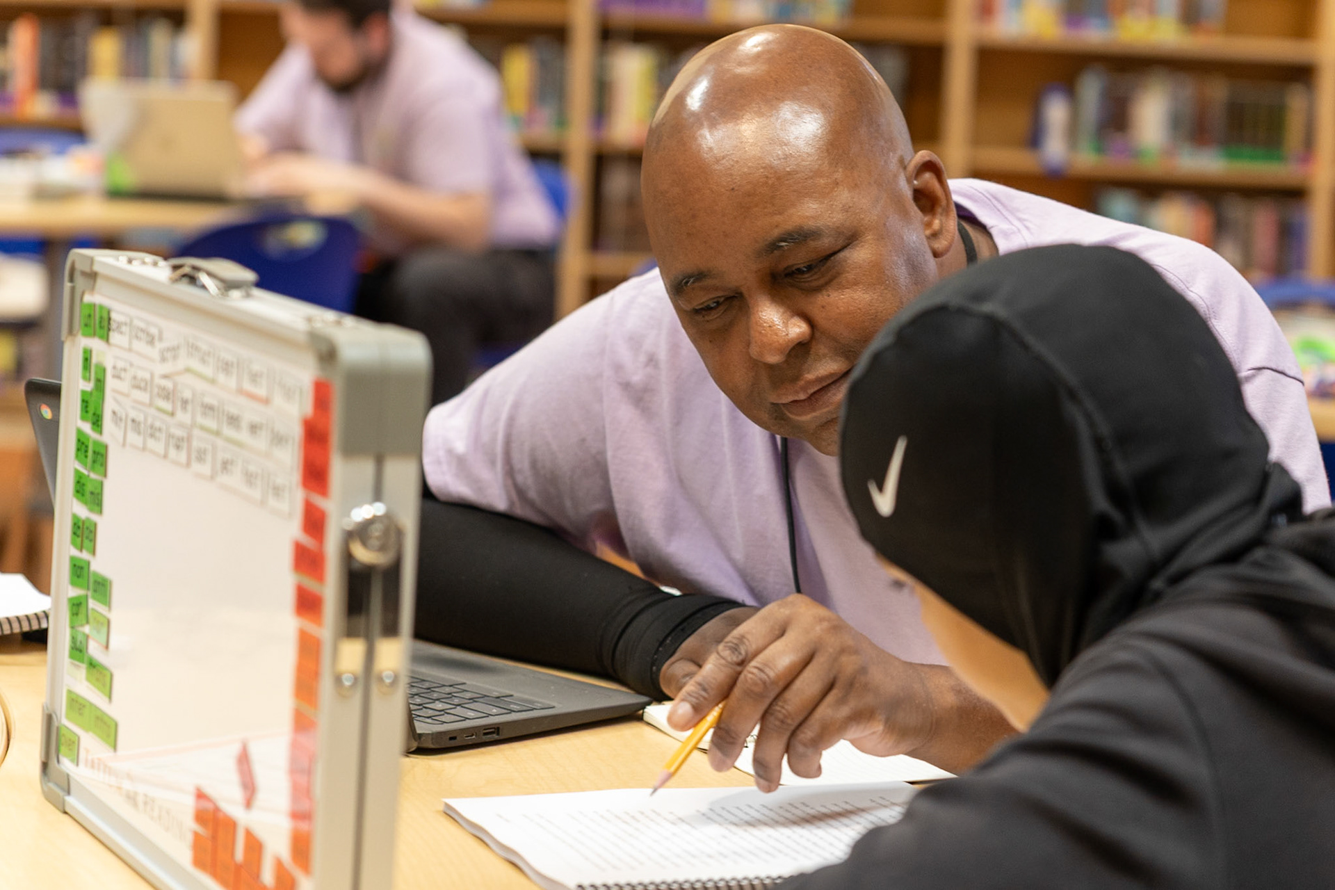 Lindell Stone, a reading tutor with the Blosser Center in Portland, Oregon, works with a student at Ockley Green Middle School on July 2, 2025. The nonprofit Blosser Center provides literacy support for students with dyslexia and other learning challenges, including one-on-one tutoring,  summer camps, and special events.