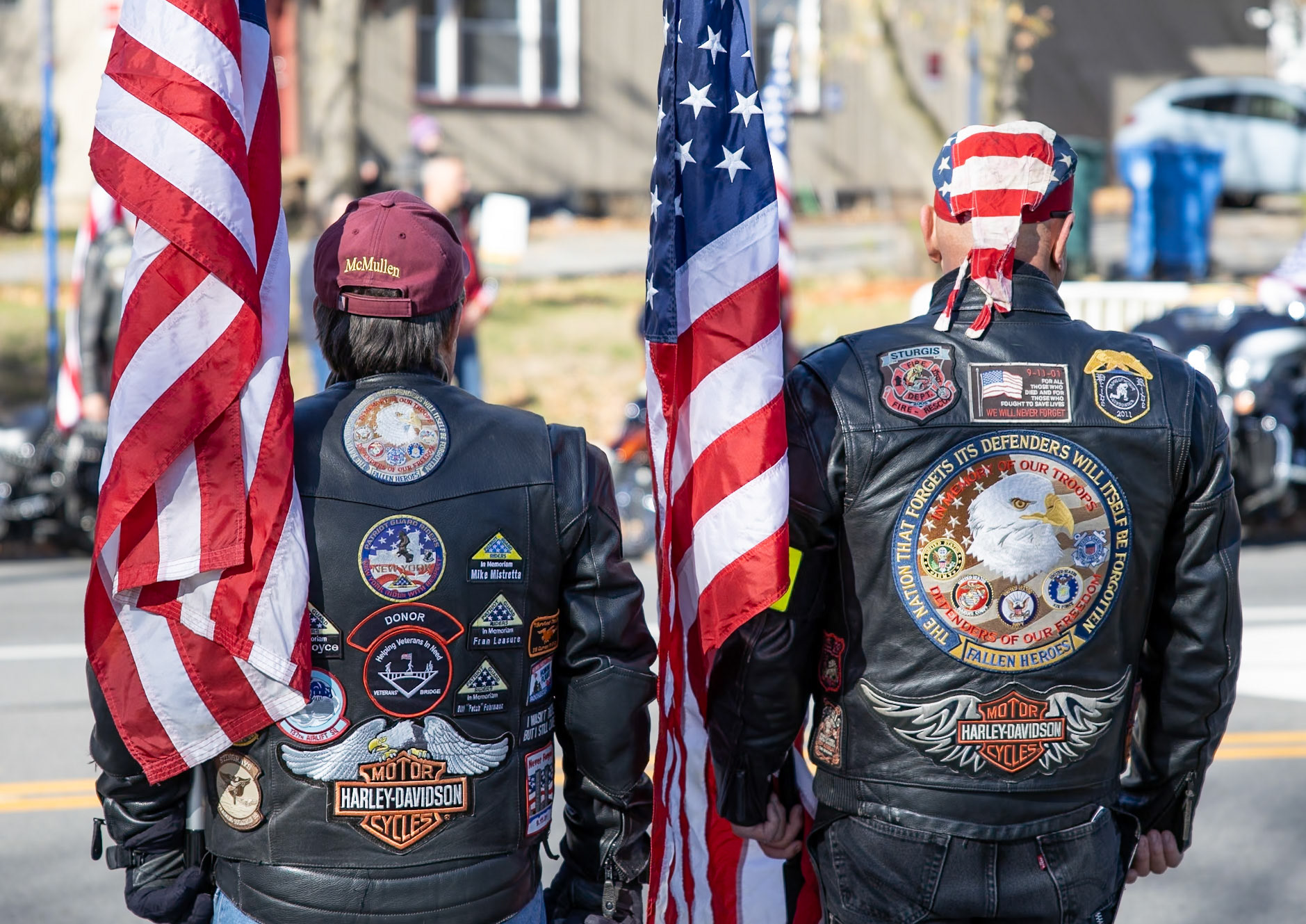 Two Patriot Guard riders stand proud in their motorcycle jacket to watch the Veterans Day parade in Rochester, New York on Nov. 9, 2024.