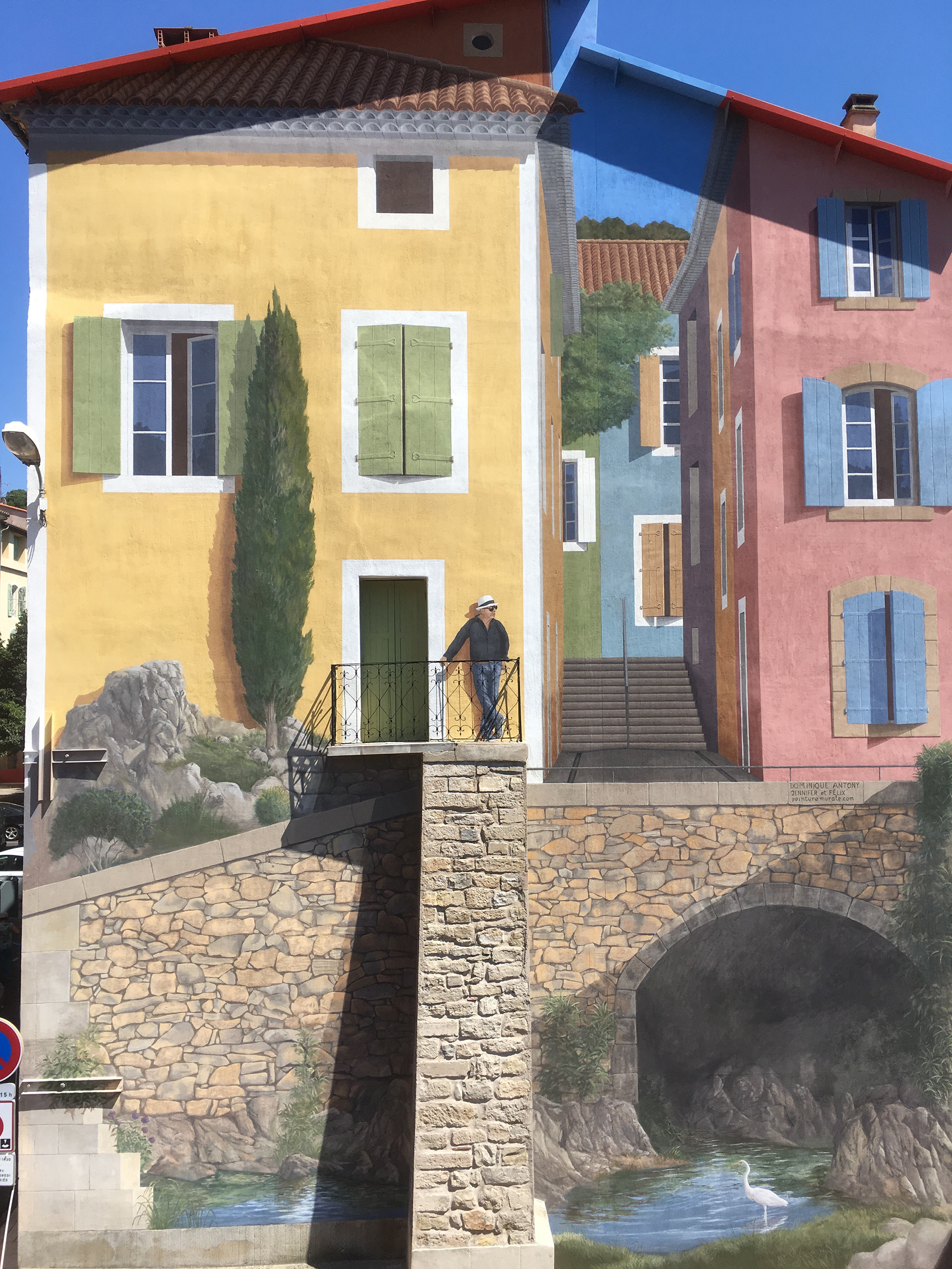  The colors are the same on the houses of the town. The  underground river  surging in this painting is typical of others in towns of the region. The perspective is carefully calculated to make the architecture look convincing and has produced an architectural trompe-l’oeil. Everything here is painted: the tiles, the shutters and windows, the alley, stairs, stone work the heron and the river.