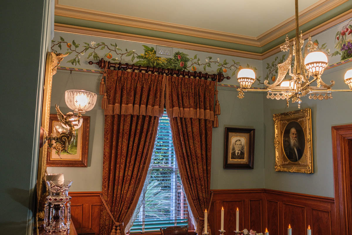 Thick curtains frame a window overlooking the garden.