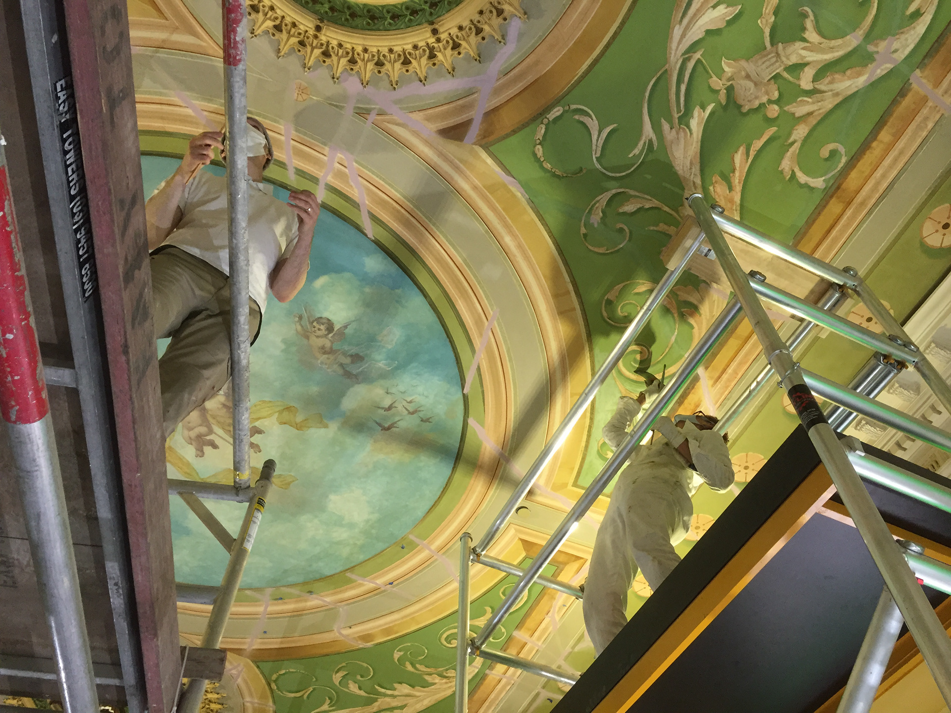 Félix and Jenny on their scaffolding, restoring the cracks