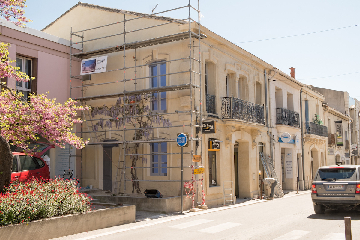 Castelnau (near Montpellier), France. Work in progress on a trompe-l'oeil facade that is a continuity of the real facade in perfect perspective