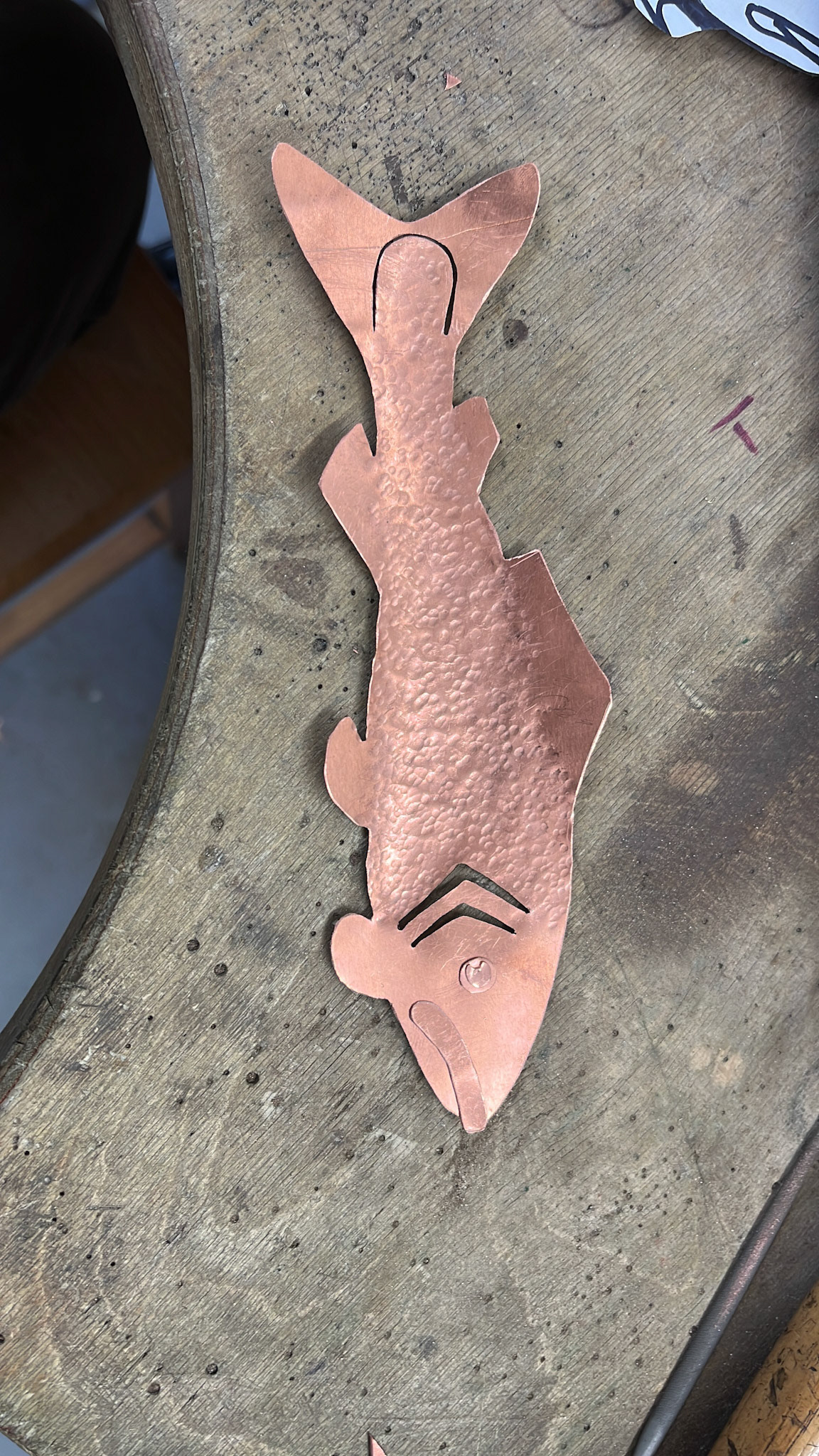 Fish after using a peen hammer to create scale-like texture on the surface.