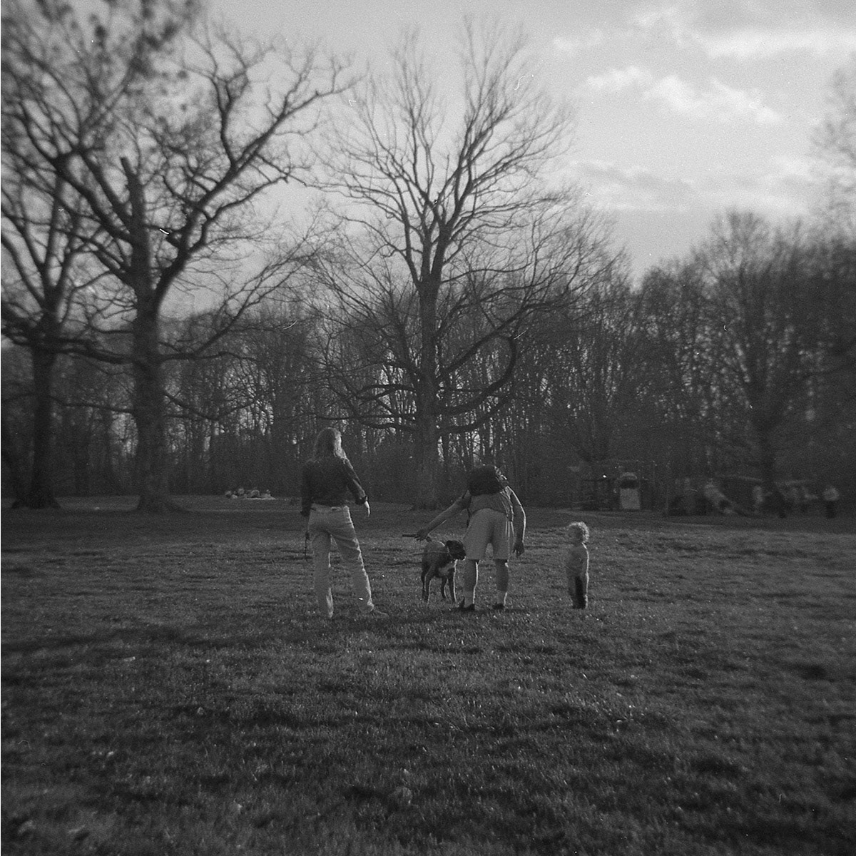 Family playing with dog, Cherokee Park, KY, Apr. 2024