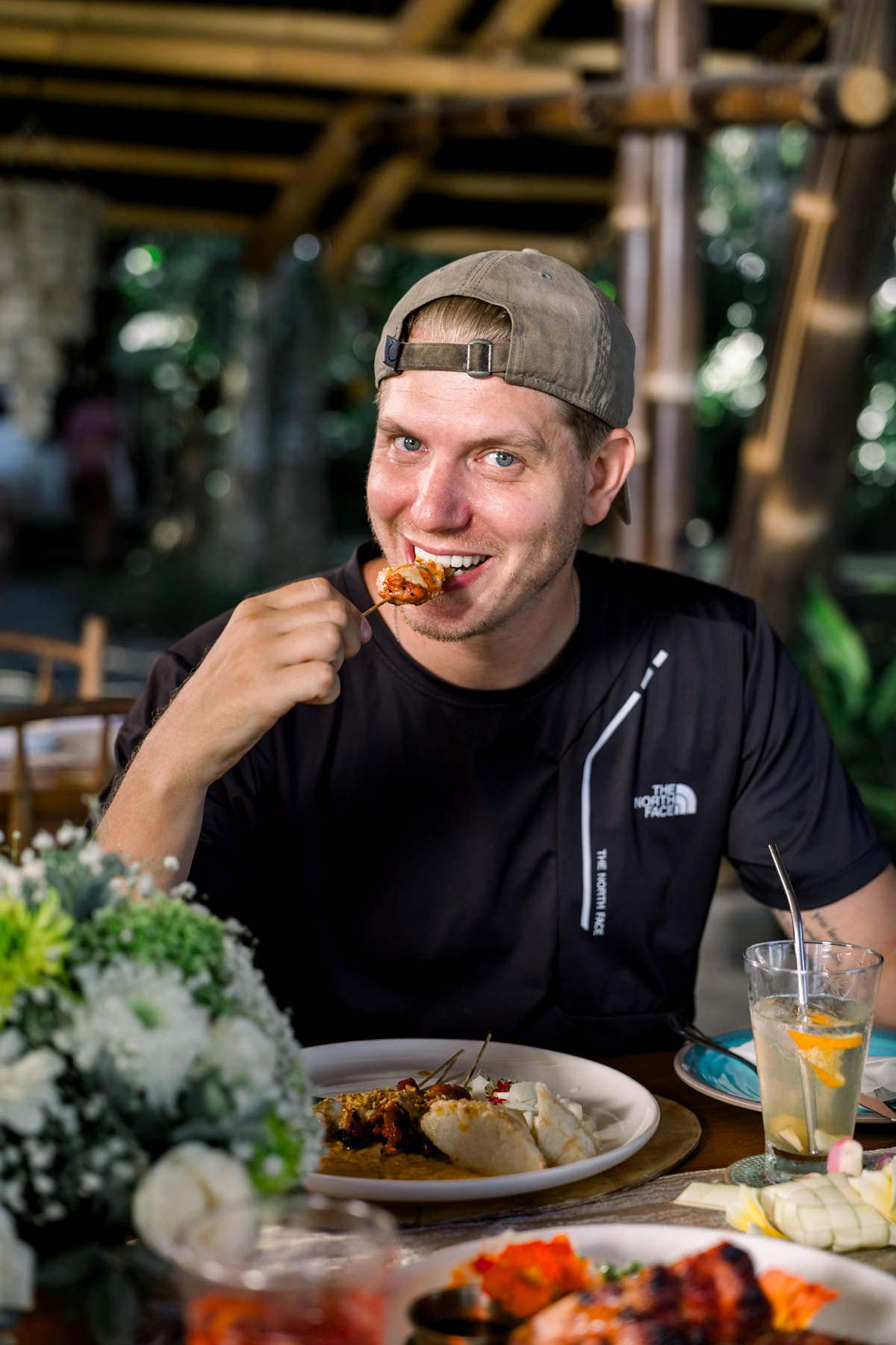 Bali food photography of the talent enjoying his satay.