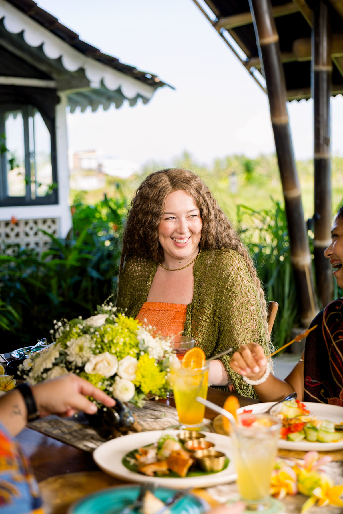 Someone enjoying her food with the friend group at a Bali restaurant.