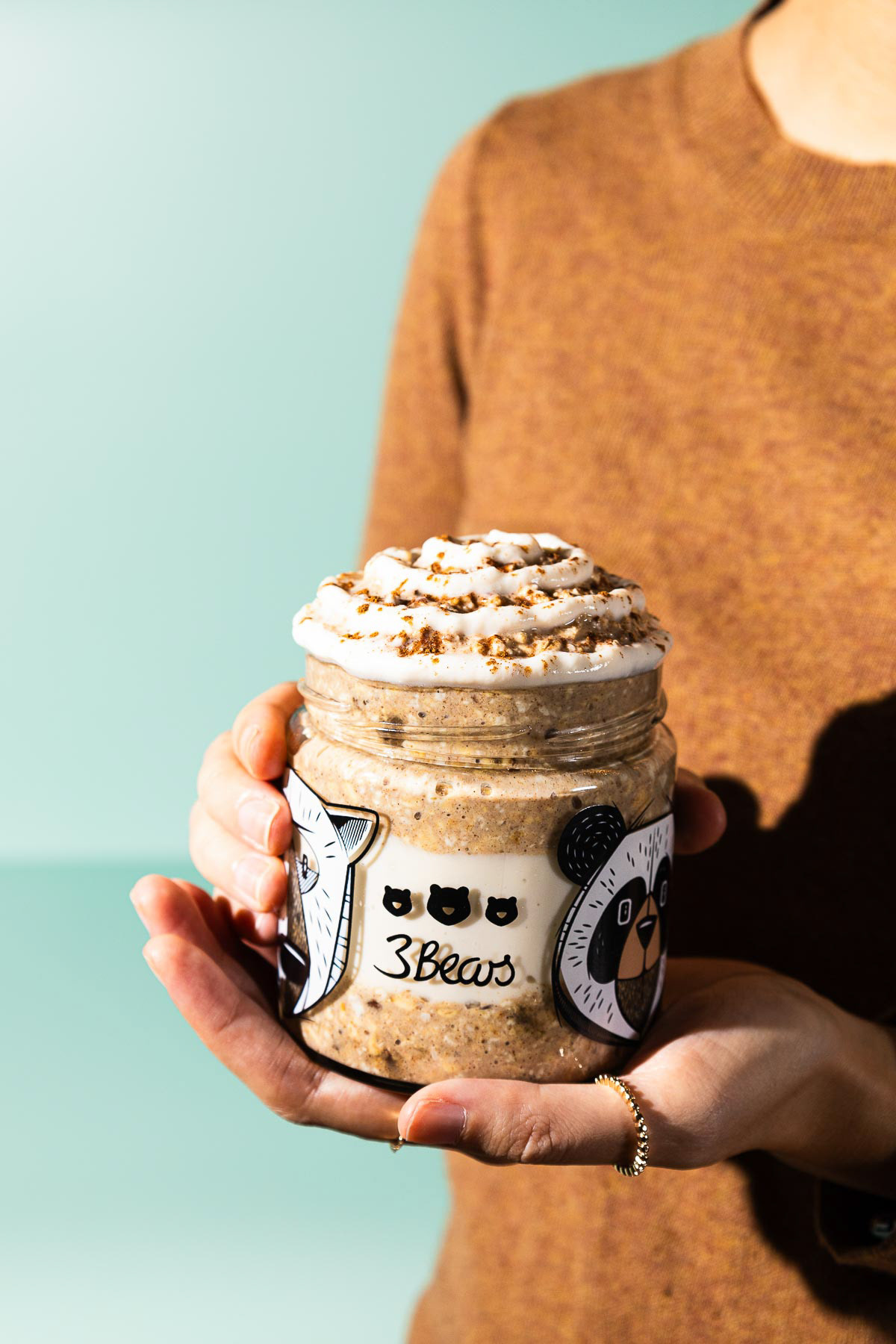 holding a jar of overnight oats
