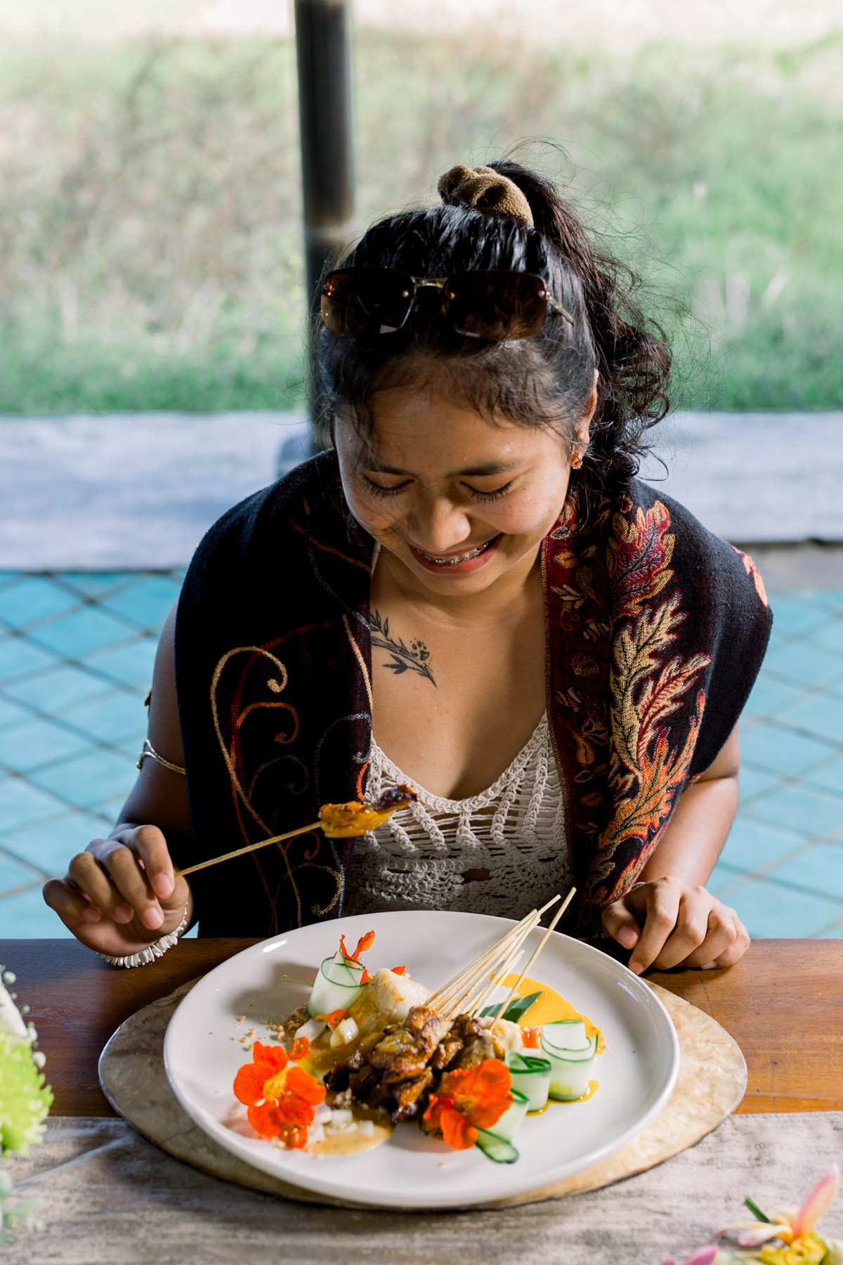 Eating satay at a restaurant in Bali.