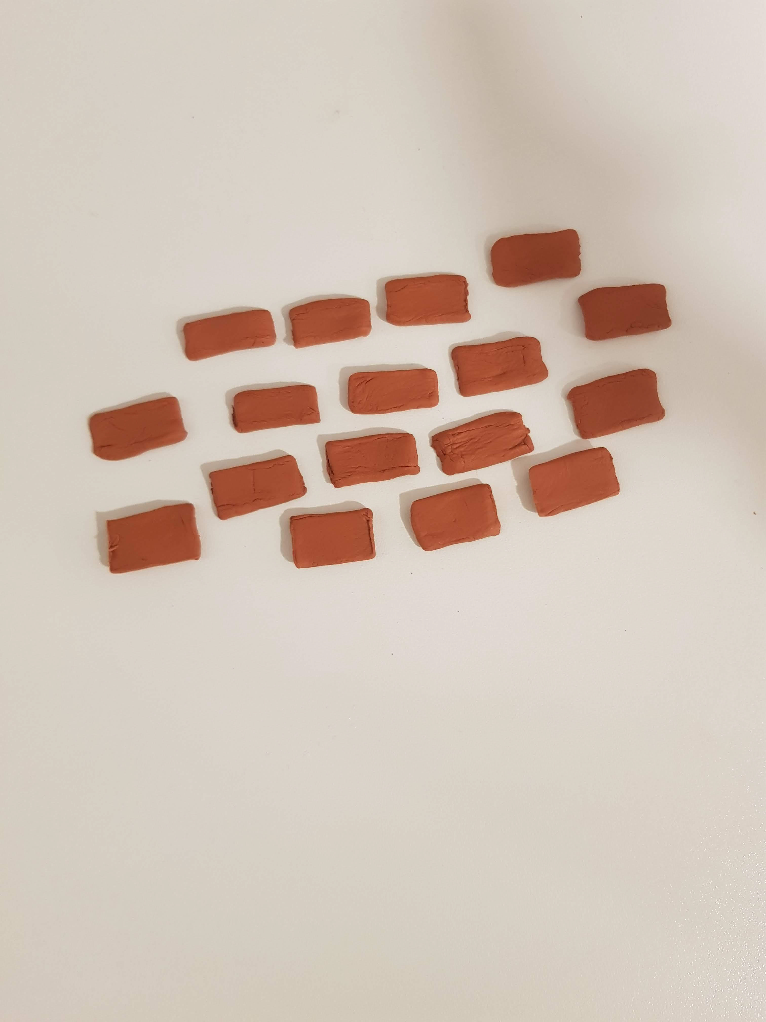 In order to make a realistic texture to add onto the dollshouse I made brick cladding, to the 1:12 scale using terracotta air-drying clay.