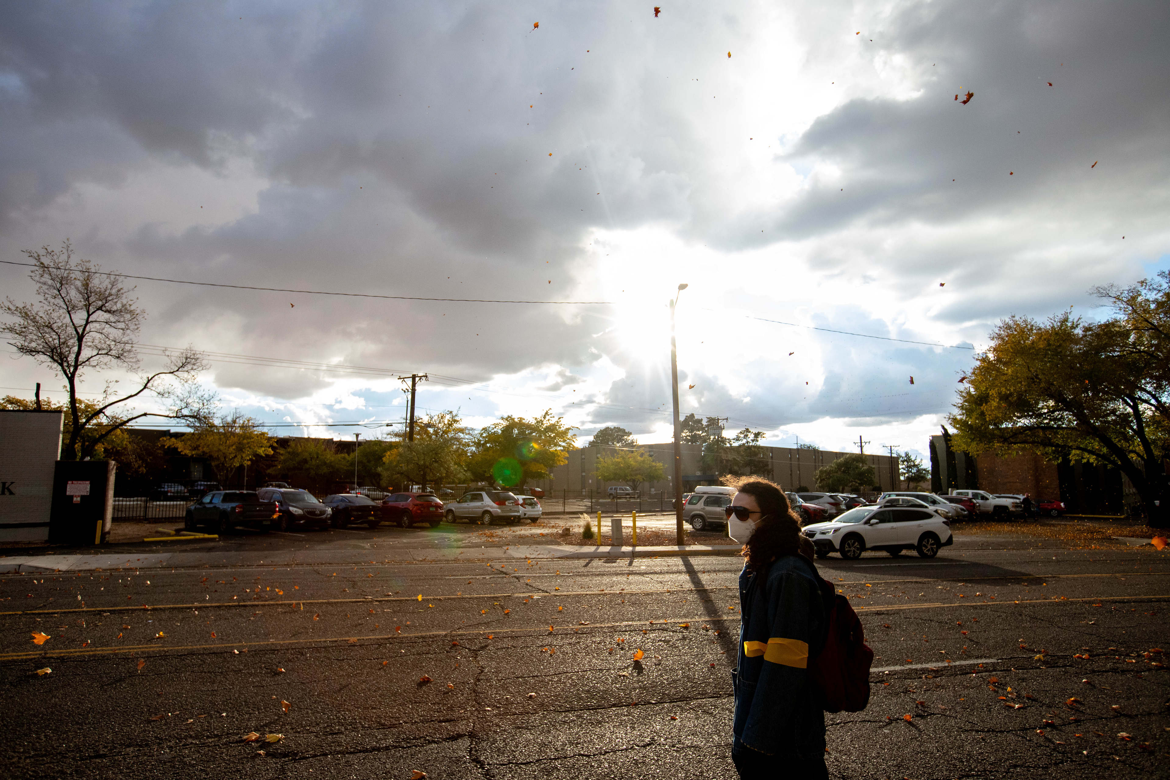 Amidst golden hour's light, a demonstrator stands solitary, a silent sentinel in protest of the 2023 Israel-Hamas war's toll on civilians, part of a "die-in" organized by Jewish Voice for Peace.