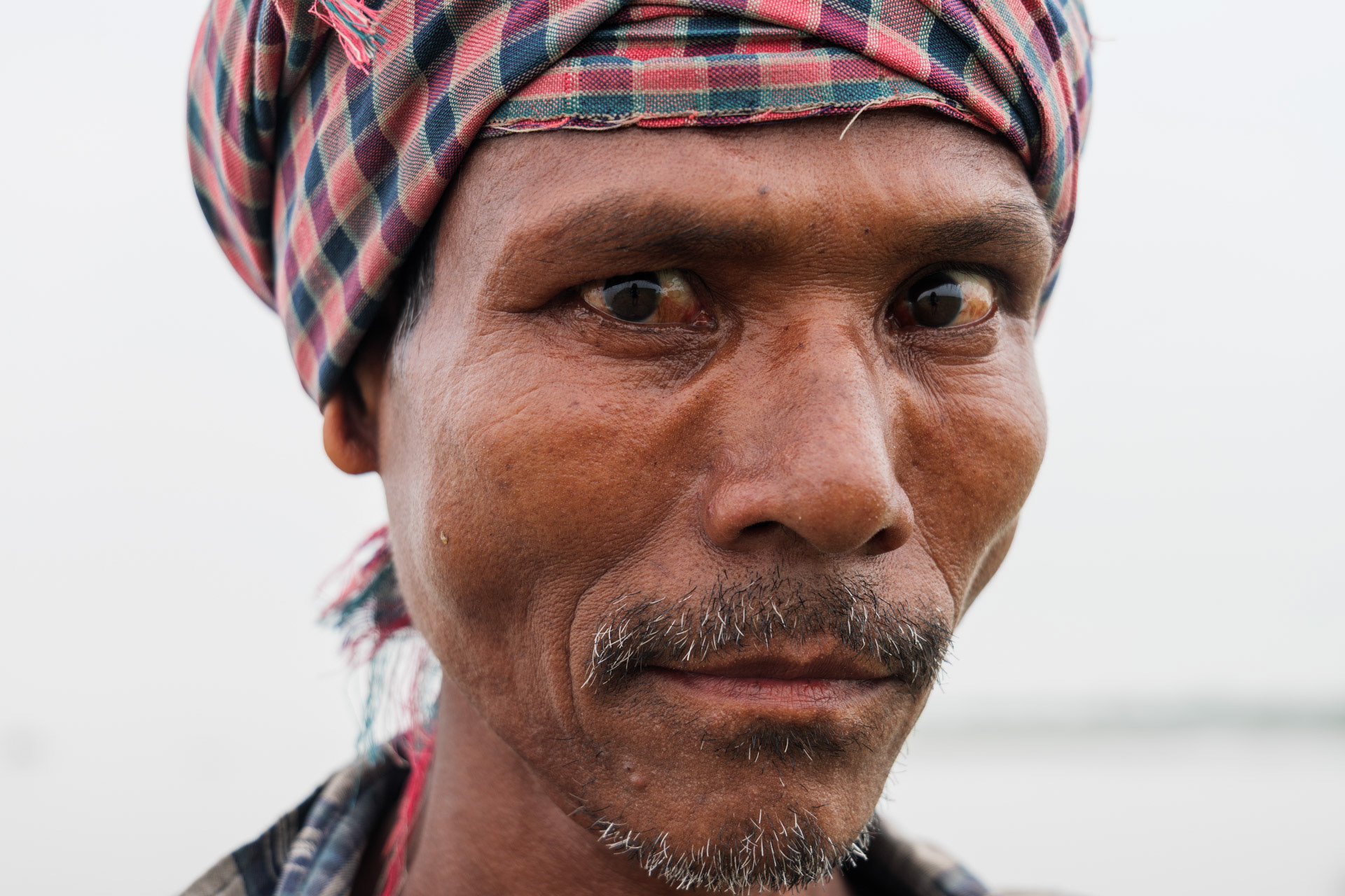A man from a jungle island on the Brahmaputra river in Assam, India