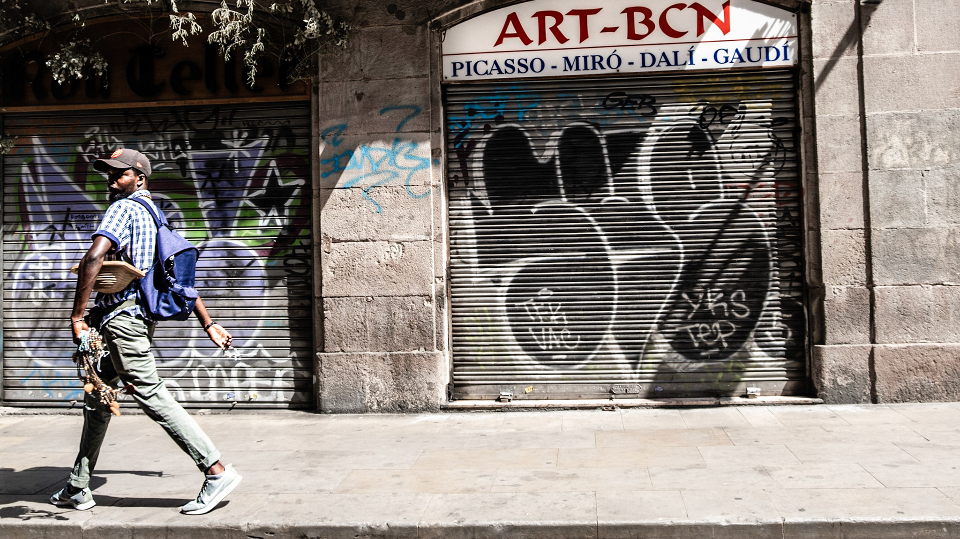 A pedestrian walks in El Born district in Barcelona, a barrio famous for its street art and plenty of galleries and museums