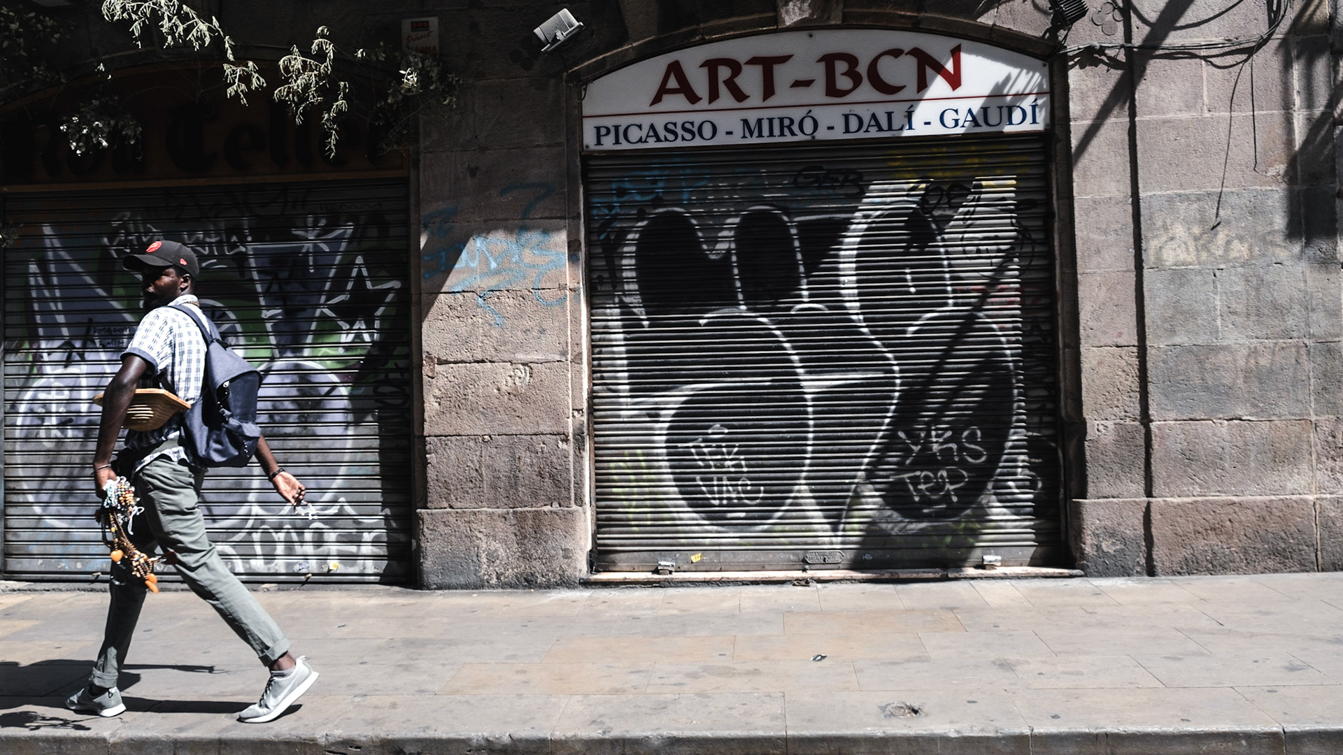 A pedestrian walks in El Born district in Barcelona, a barrio famous for its street art and plenty of galleries and museums
