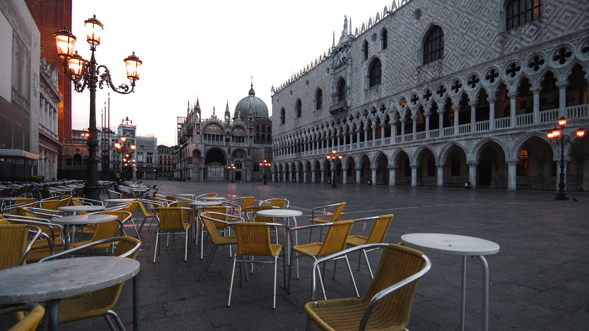 Yellow restaurant chairs on a deserted early-morning Piazza San Marco.