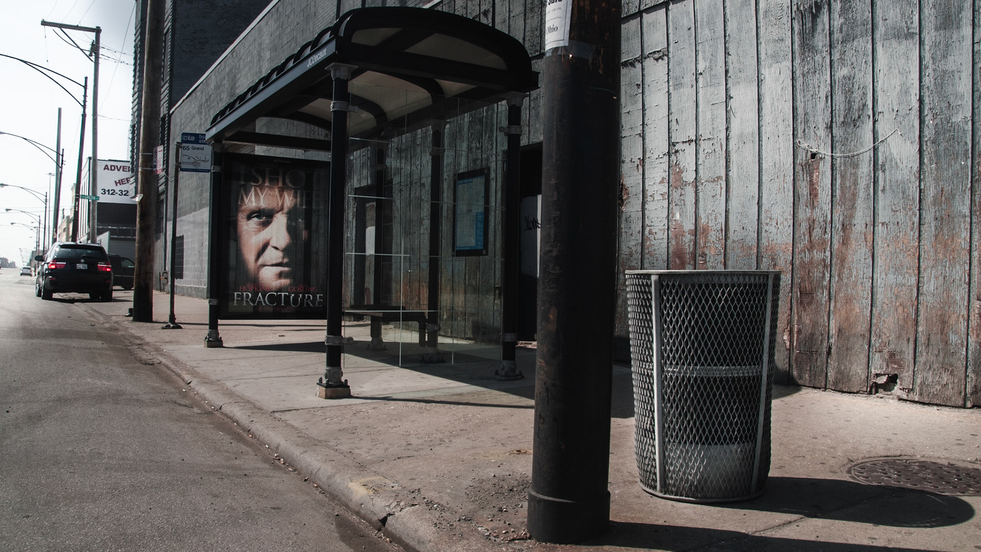 A bus stop near a vacant old commercial warehouse building on Grand and Halsted.A plan for 12-story 144 unit condo building (known as the Grand Station)  has been canceled due to the collapse of real-estate market in the United States in 2008.