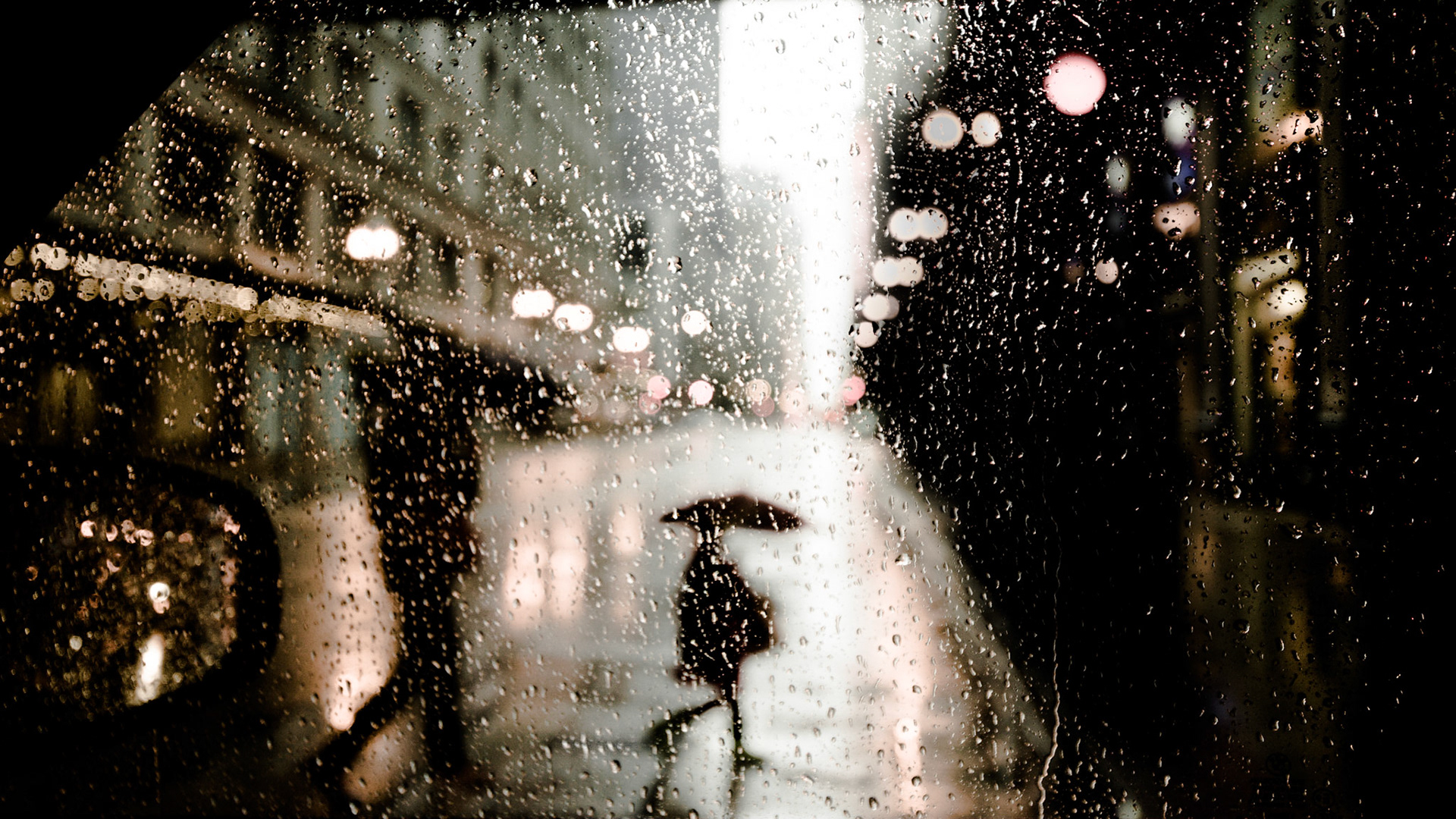 A child crosses the street in heavy rain near Washington and Wabash in Chicago.