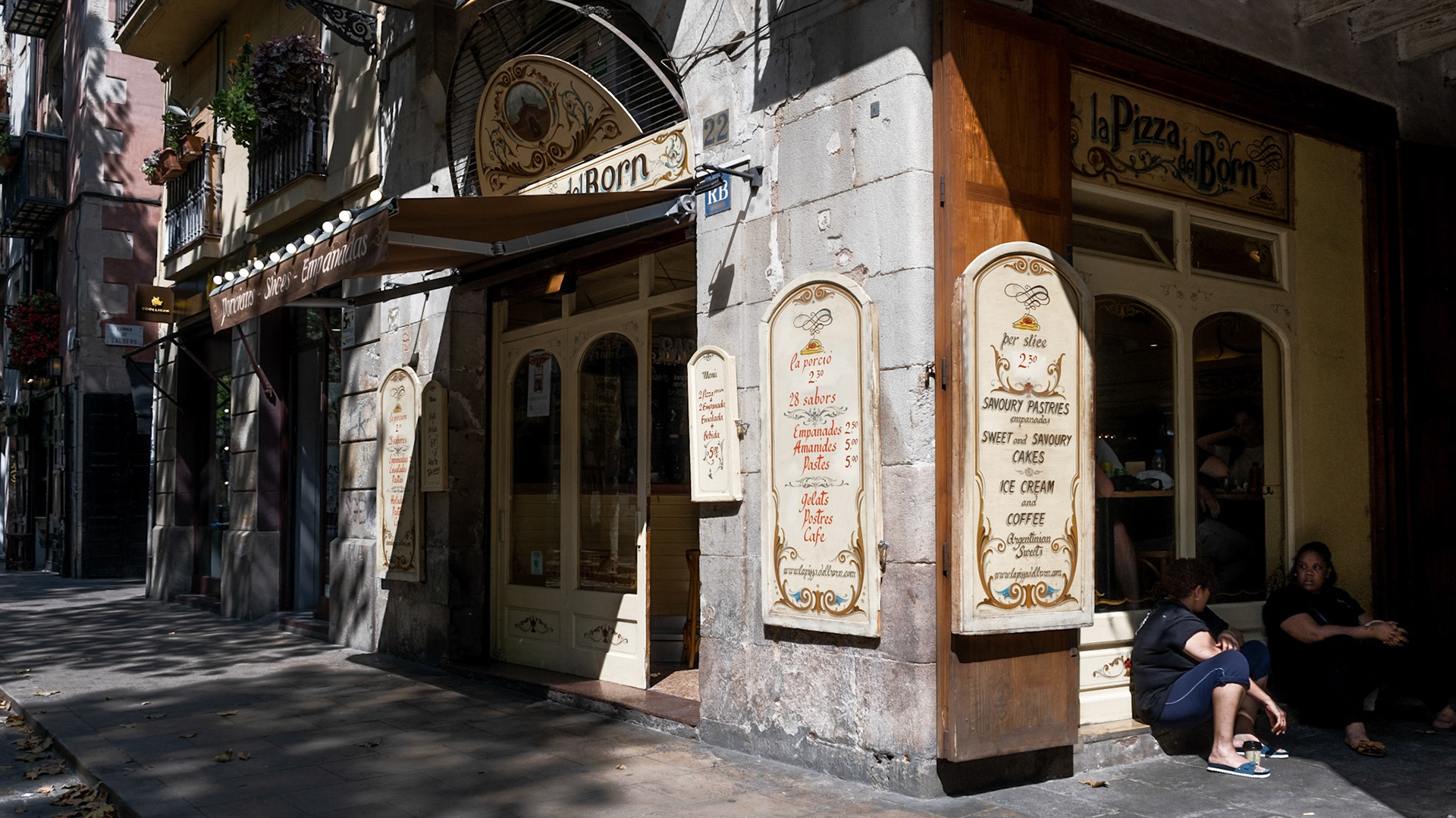 Locals on a cigarette break hiding from the afternoon sun in El Born, Barcelona