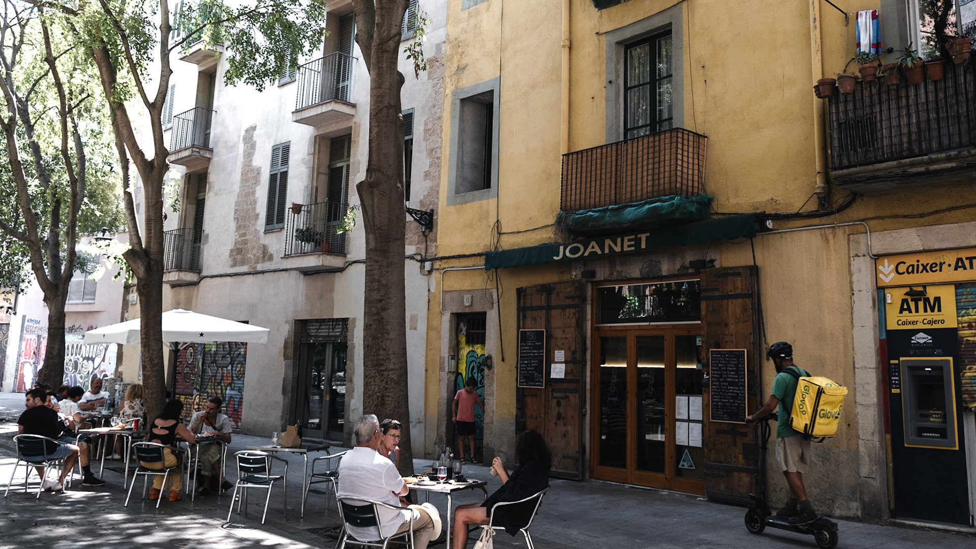 Locals and tourists alike enjoy their mid-day coffee on Plaça de Sant Aqusti Vell in Barcelona, surrouded by beautiful historic buildings