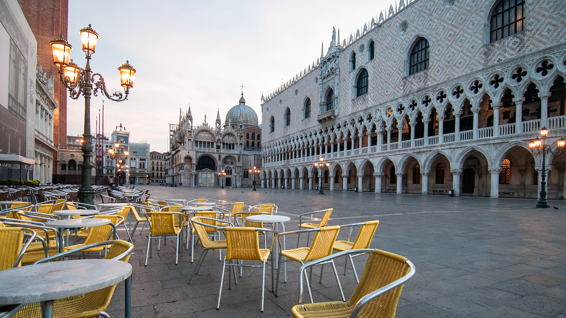 Yellow restaurant chairs on a deserted early-morning Piazza San Marco.