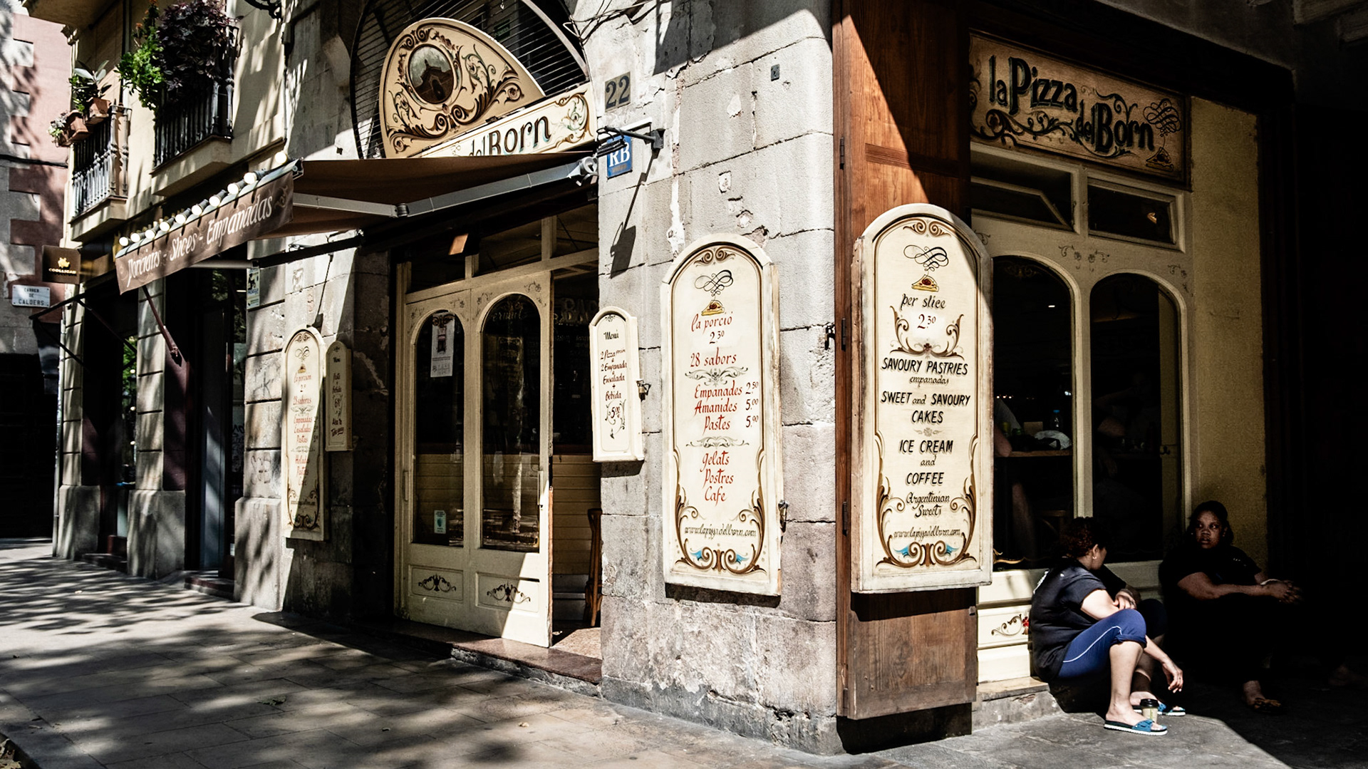 Locals on a cigarette break hiding from the afternoon sun in El Born, Barcelona