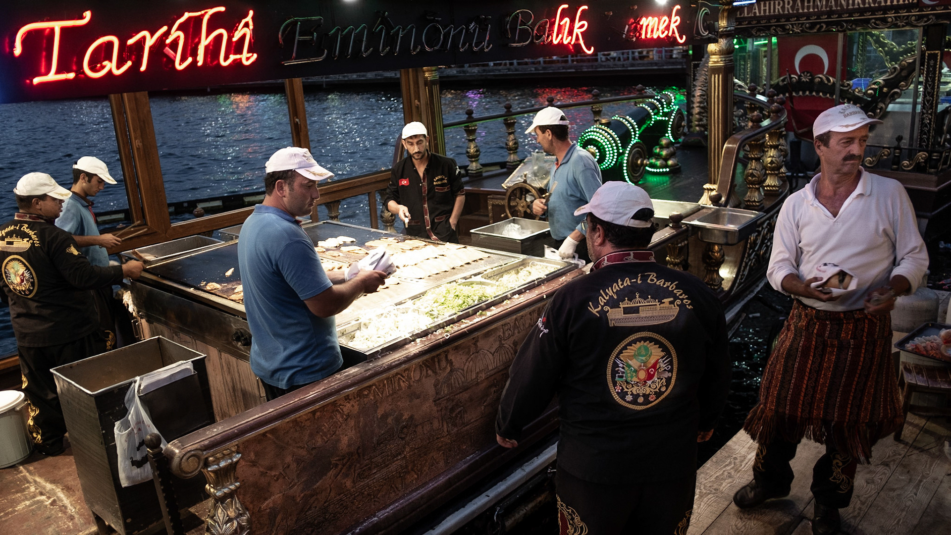 A traditional snack: fish, onion and salt in bread, all freshly grilled on a boat anchored to the pier.