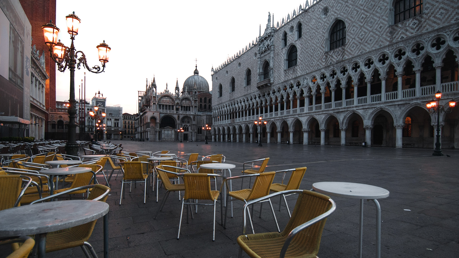 Yellow restaurant chairs on a deserted early-morning Piazza San Marco.