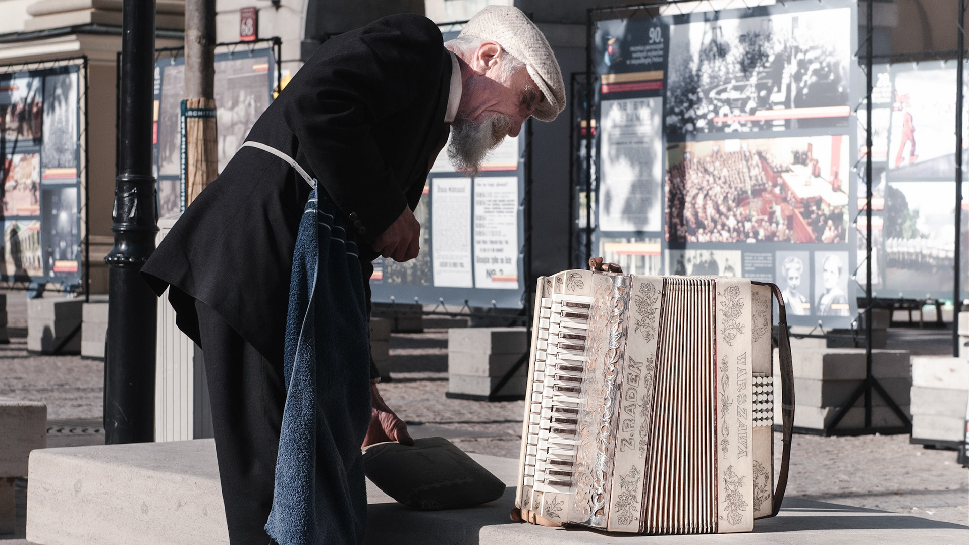 An old street musician gets his accordion ready for another session on Krakowskie Przedmieście in Warsaw.