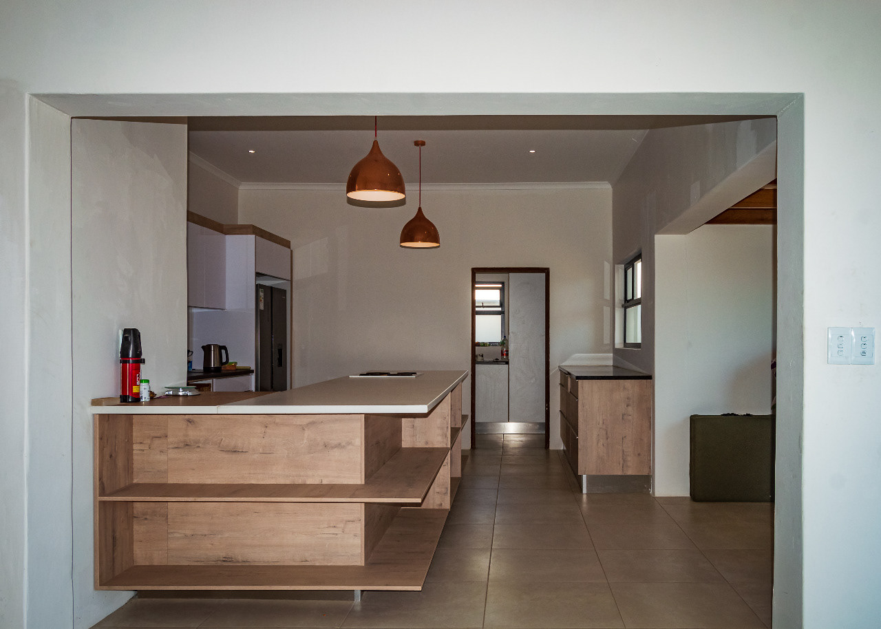A view of the communal kitchen and entrance to the washing-up area from the lounge.
