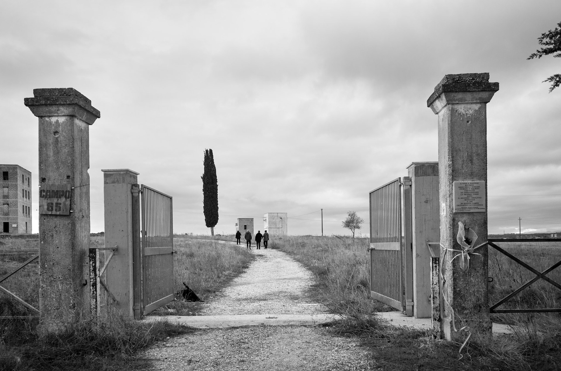 Entrance to Camp 65. December 9, 2023. Domenico Bolognese, president of the Campo 65 Association, guides Slovenian journalist Milos Batistuta and his crew during the filming of a documentary on the Overseas Brigades for the Slovenian public broadcaster TV Koper-Capodistria.