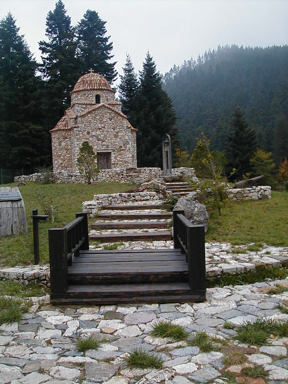 small wood bridge is the main path over the creek to the church